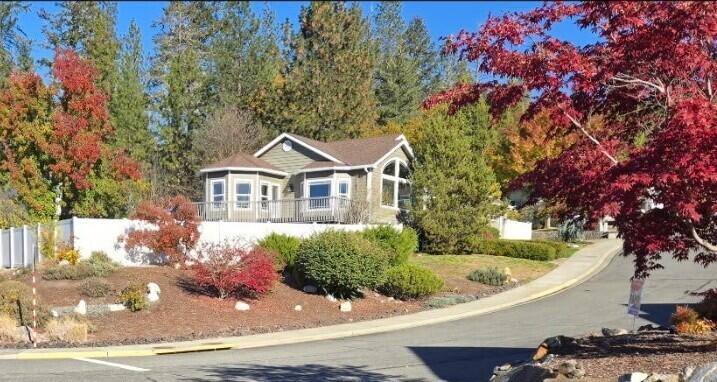 Beautiful 3 bedroom, 2 bathroom home on .37 acres offering an open-concept layout and STUNNING views! RV parking to accommodate 45' long with 30 amp service! Light-filled living room features vaulted ceilings, hardwood floors, and large bay windows. Formal dining room includes a tray ceiling and opens to a spacious wrap-around deck with a retractable awning perfect for enjoying the scenery. The kitchen has stainless steel appliances, a double-oven gas range, breakfast nook with bay windows, and deck access. First bedroom features glass French doors, ideal for a home office or flex space. The primary suite offers a private screened-in covered patio, jetted corner tub, step-in shower, and a walk-in closet. The laundry room opens up to a 2 car garage. Additional walk-in storage is located beneath the home. The fully fenced and landscaped yard includes front and rear sprinklers. New roof Aug. 2022, new interior and exterior paint 2020, new water heater 2020, new garbage disposal 2022