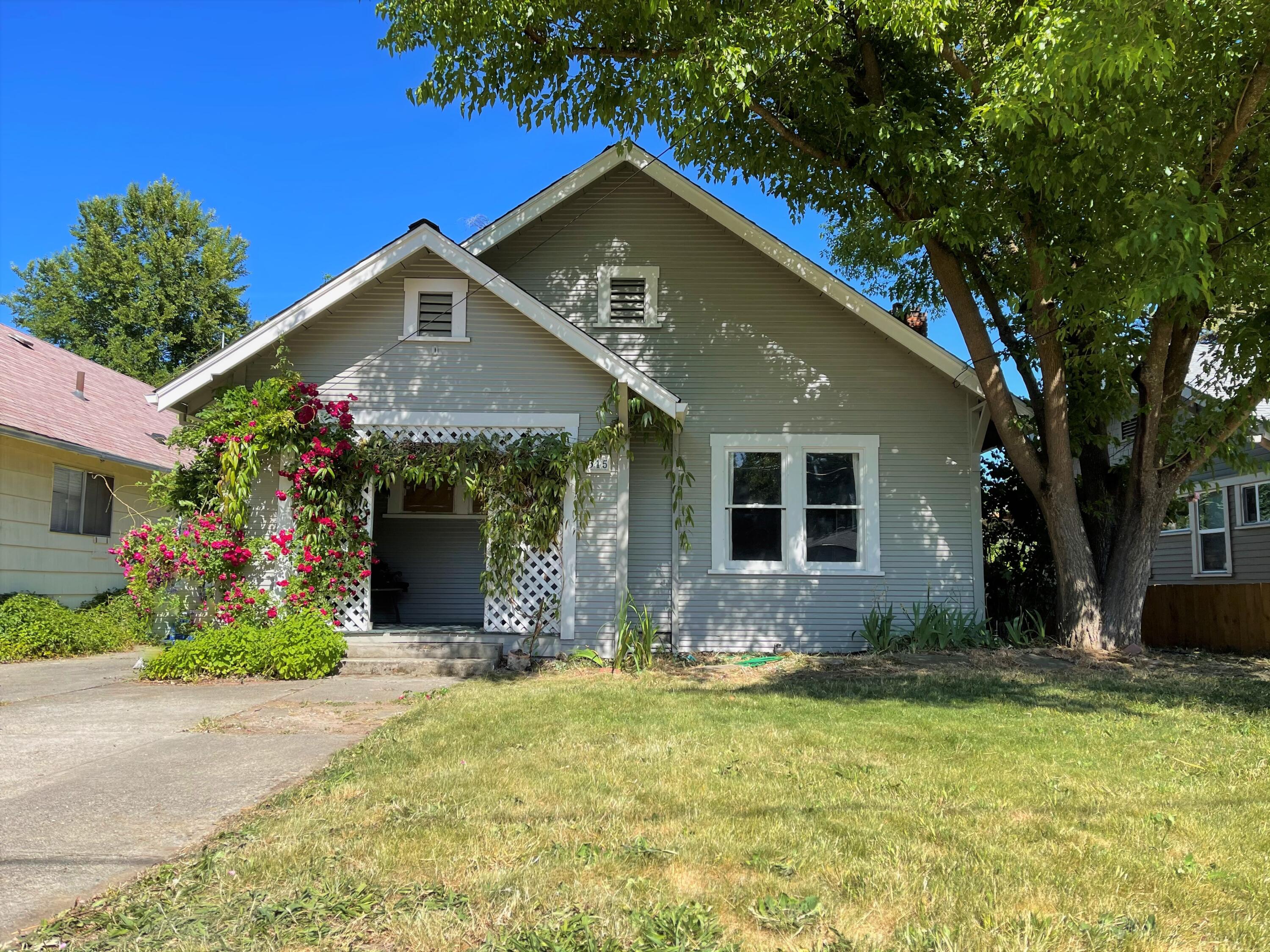 All the style and charm of 1928 with modern conveniences. This is an adorable and freashly painted 3 brm, 1 bath with an additional office or nursery off of the master bedroom. The quaint front porch welcomes you with vine covered lattice. Step through the front door and back in time in the elegant living room with real hardwood floors, built-in bookcases flanking the fireplace and a vintage feel light fixture. The kitchen functions like a more modern one with updated wood cabinets installed in the 90's and a bright Farmhouse style Kitchen/dining room. Off of this room is the Laundry/planting/craft room. Every room has a built-in from the time period. There is a old barn style garage with dirt floor that could be reinvented into a shop. Alley access would allow for future additional parking for cars, RV parking or toys. Large fenced private back yard with mature landscaping just waiting for your green thumb.