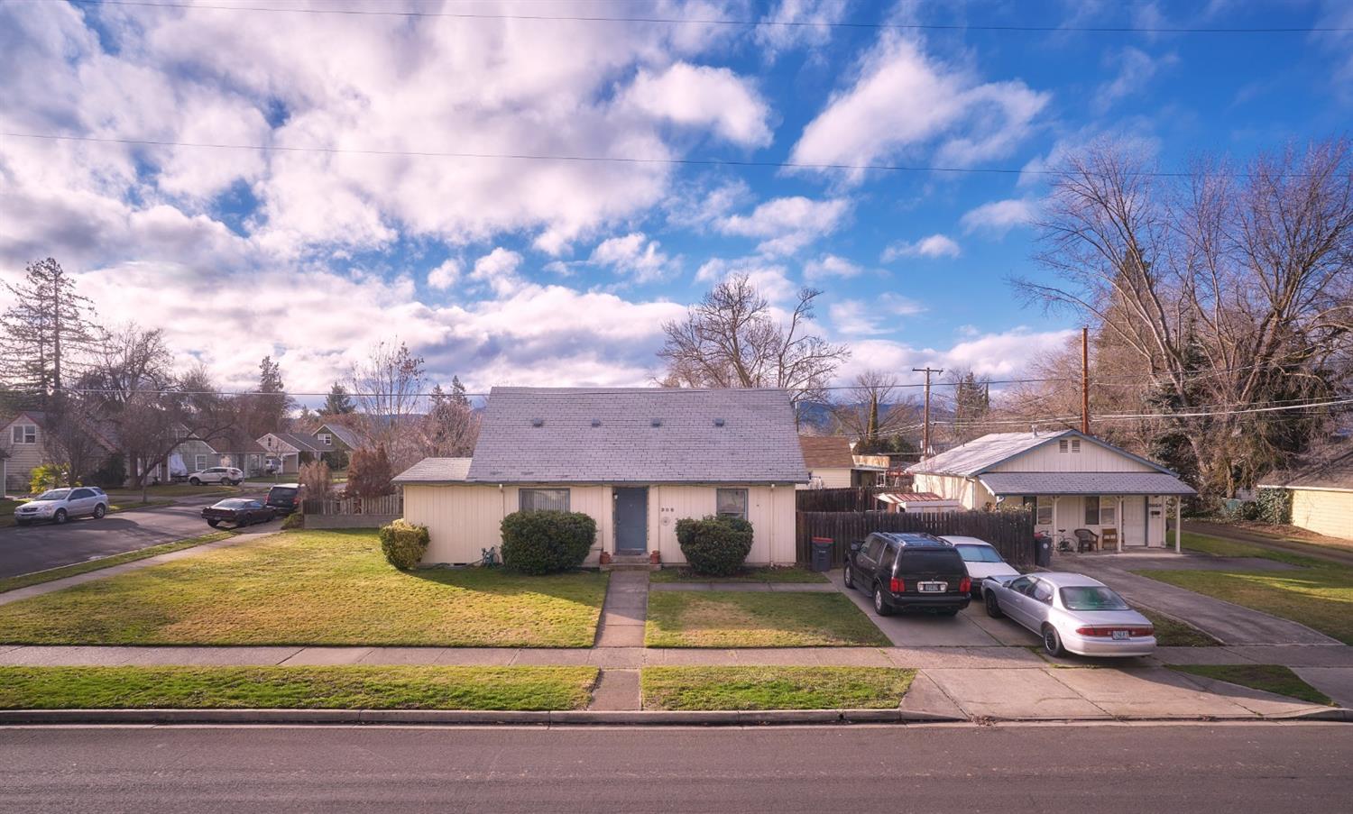 Fantastic investment opportunity or two-family set up. Two single-family homes located on a larger corner lot in a neighborhood of well-kept homes. The primary home is 1372 sq ft with two bedrooms and a full bath downstairs. Upstairs is a large 3rd bedroom along with a den/office space that could serve as a small 4th bedroom. Open living room, dining area off the kitchen and dedicated laundry room. Fully fenced back yard. The smaller home is a tidy, newer build home with an open floor plan, single bedroom, en-suite bath and new water heater. Both long term tenants would love to stay. Property is professionally managed. Seller is a licensed broker in the state of Oregon. 1 year home warranty included at no cost to buyer.