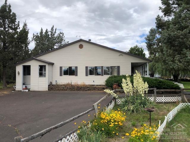 Beautiful mountain views from this 5.94 acre EFU property, 4 acres irrigated. This 2202 s.f. home has lots of storage, built in pantry cupboards, large utility room with space for additional freezer and refrigerators. King sized master suite with large walk-in closet, spacious bath with jetted tub, shower and enclosed W/C. The large 180 s.f. covered back porch is large enough for the porch swing and picnic table. The 4 bay garage includes RV bay shop area as well as a loft area and storage rooms. The 3 stall horse barn includes an office space or tack room. The above ground pool and deck with terrific mountain view have entertained families for years.