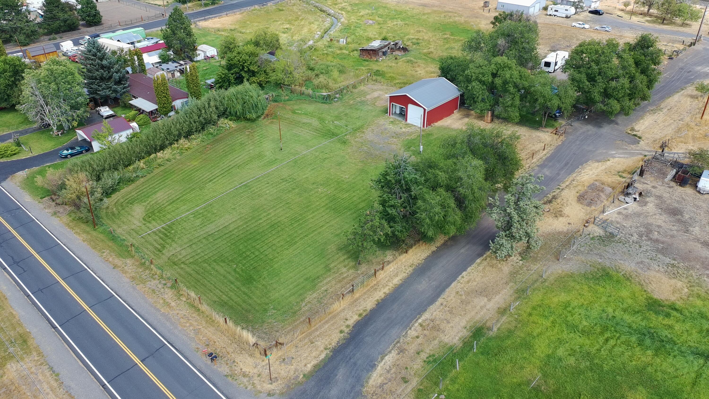 Hard-to-Find Acreage in the Heart of Terrebonne! Don't miss this rare opportunity to own a 1+ acre parcel on a prime corner lot in Terrebonne complete with .82-acres of COID irrigation water. A standout feature is the 36'x30' METAL POLE BARN SHOP boasting 2 tall doors, concrete flooring and power - ideal for storing toys, working on projects or running a small business. This fully fenced property with an access gate offers endless possibilities - whether you're looking to build your dream home, place a manufactured home or create an ideal vacation retreat in the center of Central Oregon's outdoor paradise. Only minutes from Smith Rock State Park, local rivers, reservoirs, restaurants, grocery stores and other amenities. Enjoy stunning mountain views and ample space to park equipment, RVs and more. With potential for future parcel division, this property is both a solid investment and a lifestyle opportunity. Properties like this don't come around often - act now before it's gone!