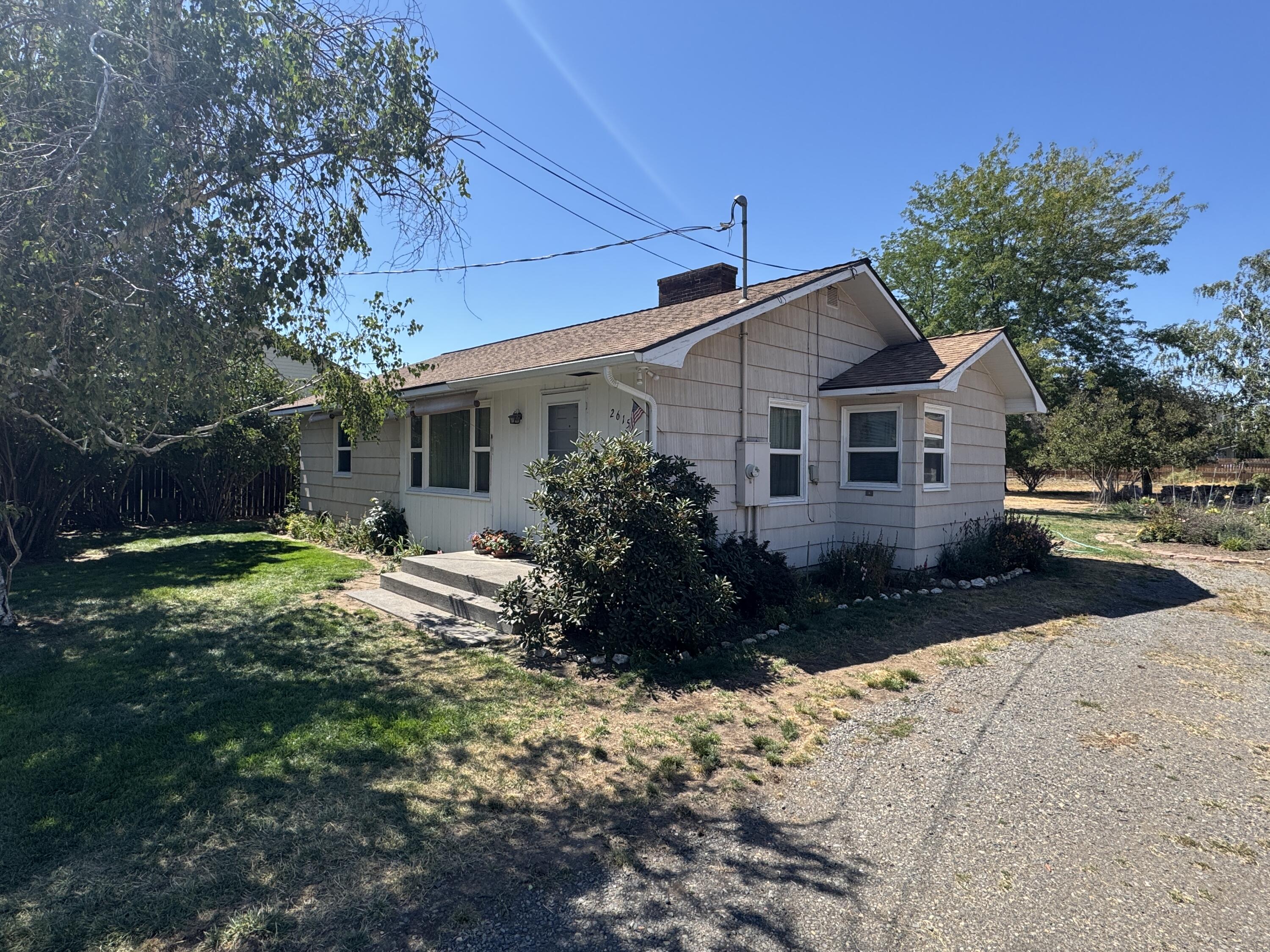 Charming Single-Level Home on Nearly an Acre of Prime High Density Development Land in SW Redmond! Don't miss out on this well-maintained home located in an area of dense development just blocks from Hwy 97 & all of Redmond's amenities. This property offers endless possibilities, enjoy the serene setting now or take advantage of its great development potential. Inside, you'll find a comfortable floorplan featuring electric forced air heat & A/C, a wood-burning fireplace, & a spacious bathroom w/a tiled shower/tub combo. The roof was replaced around 10 years ago, providing peace of mind for years to come. Outside, the detached 2-car garage is complete w/a garage door opener & two storage rooms perfect for projects & hobbies. The beautifully landscaped yard is filled w/mature trees & flower gardens, offering a peaceful retreat & room for animals, RV & toys. Whether you're looking for a move-in ready home w/space to grow or an investment opportunity, this property checks all the boxes!