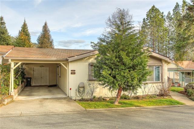 For the young at heart...this 55+ community is nestled away in between mature pines yet close to town. The residents love Highland Heights so much they purchased a flag pole and dedicated it to the Owner and Manager. This adorable home has so much to offer. The beautiful foliage in the front can't wait to wake up this spring. Enjoy the scenery from the large front covered porch which would make an ideal place for morning coffee or to just relax on a peaceful afternoon. The mini stone walk path guides you to the strawberry patches which outline and surround the base of the home. In between those and the rock garden is an existing planter box for the garden enthusiast. Another stone walk path will lead you to the back. The attached shop is 11 x 27. Tell your Realtor you would like to view this property, because once you experience this special community, you will want to call it home.