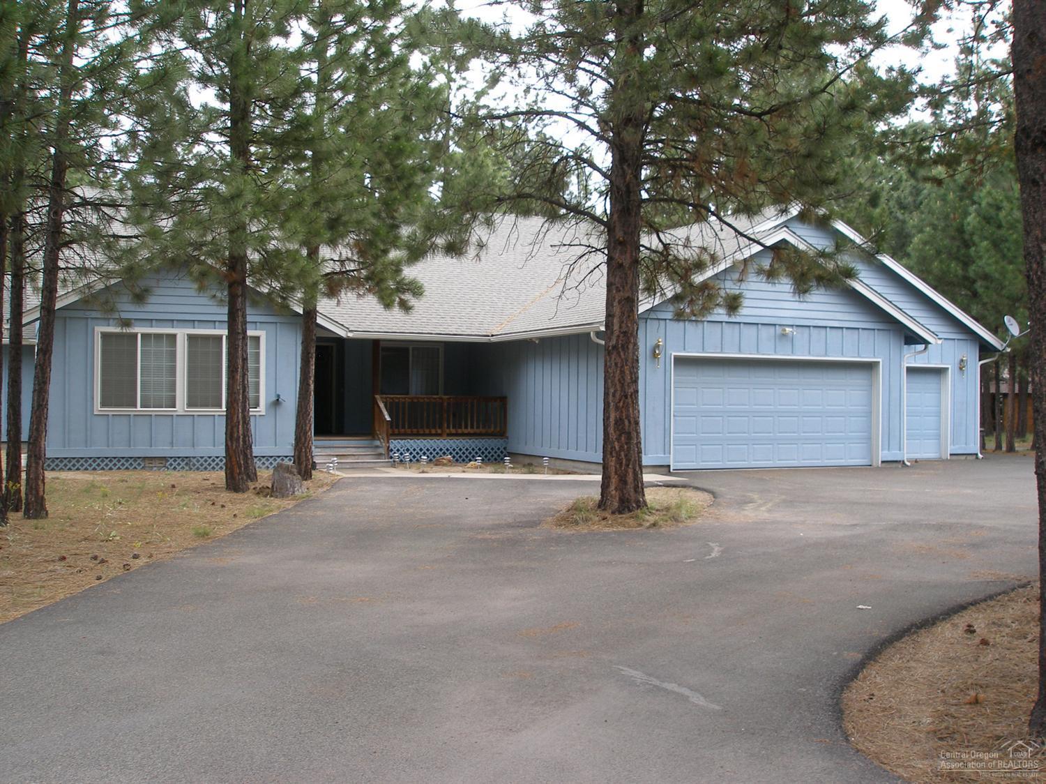 Forest living, in Ponderosa Pines, near lakes and river. Smell the pines! Beautiful single level home, 2415 sf, with 3 beds and den. Open kitchen, large living and family rooms, 2 dining spaces, covered back patio area. Jetted tub in one bath, tiled shower in other & grab bars. Built 2003, home has had little wear. Park all your toys in 1000 ft. garage shop, with office and bath, and your RV under cover. Circular paved drive makes all the parking easy. Owner says, great neighbors, too!