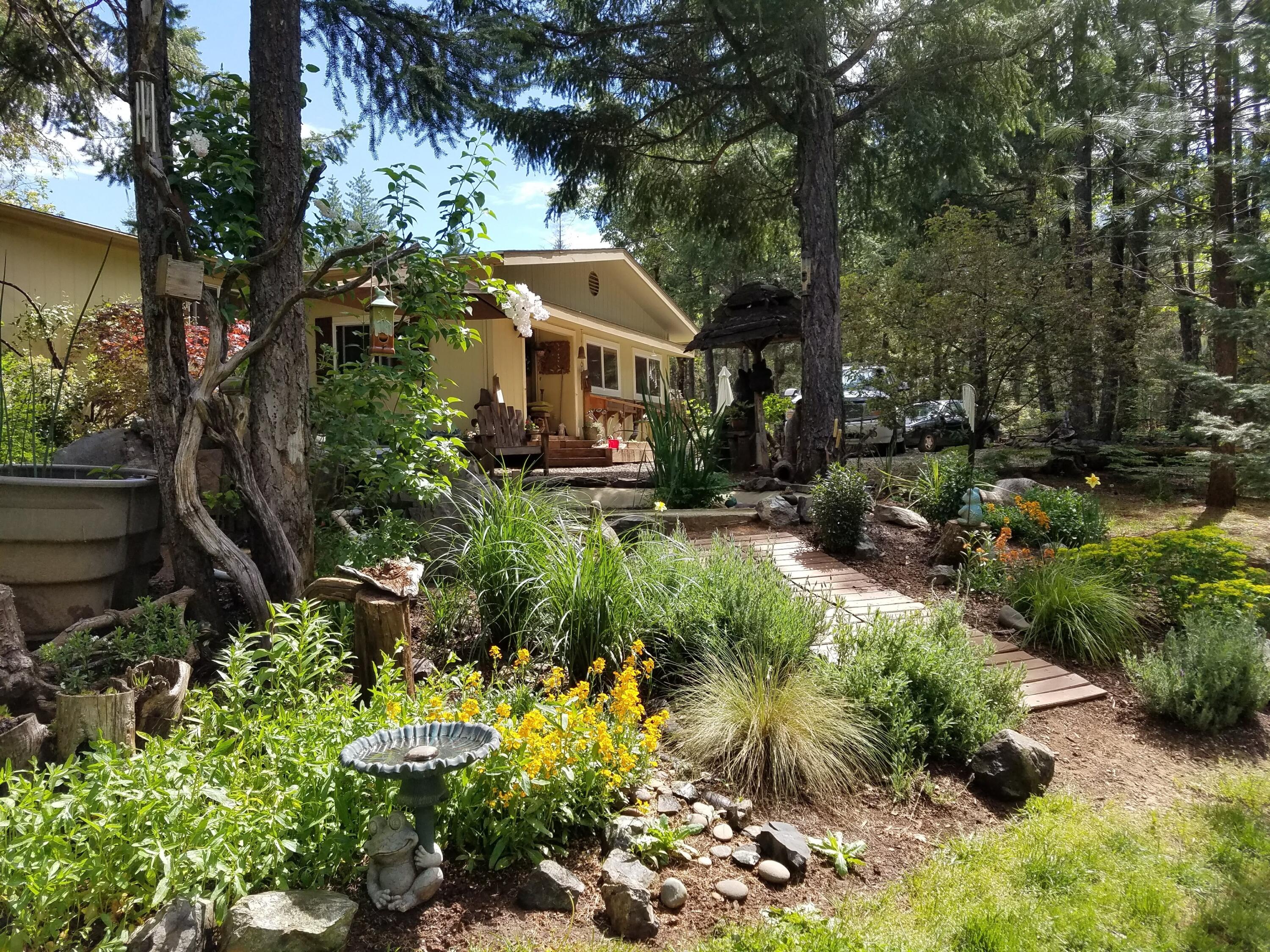 Welcome to this rare opportunity to
own this fully fenced 4.75 acres that
provides privacy, but is within distance
to town and the coast. The oversized
two-car garage provides 220 amp
service, which has a 3/4 covered
awning. Just outside the door of the
home, you're provided with a pond with
filtration & waterfall. Walking into the
home you will find a vaulted 3 bedroom
2 full bath split floor plan. Several
upgrades have been made to the home
which comes with all new appliances.
The master bedroom has an oversized
walk-in closet. The home also features
a certified wood stove and a heat
pump. A large addition is perfect for an
office or 4th bedroom. Heading to the
back of the property you will find a
great-sized backyard with a firepit that
is perfect for the whole family. Property
has a second gated access road, ATV
trails, multiple out buildings with power,
RV hookups, chicken coop, and so
much more!