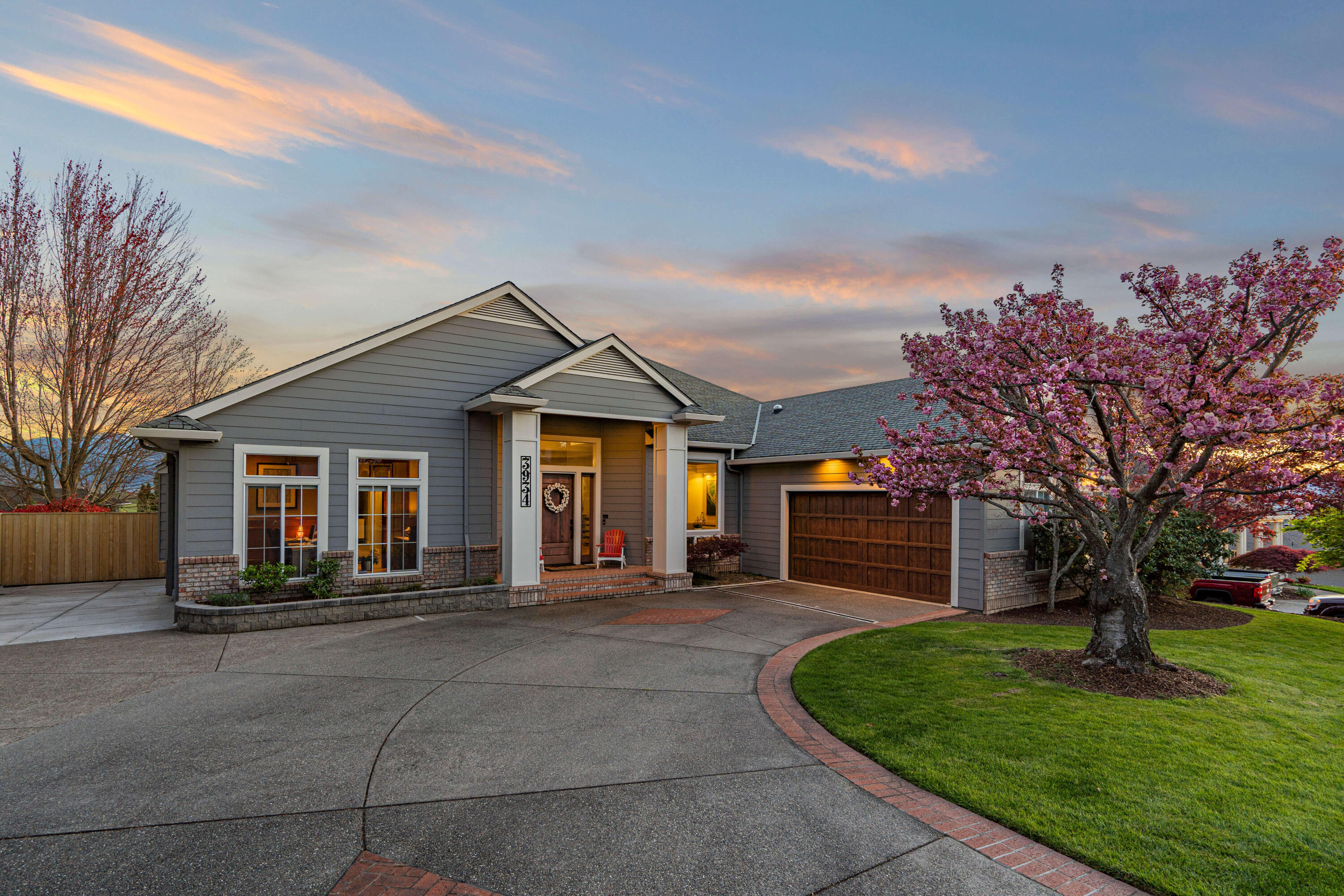 Discover unparalleled luxury at 3934 Piedmont Ter, East Medford's prestigious Cherry Lane Estates. This exquisite home boasts original oak hardwood floors, soaring 12' ceilings, and panoramic valley views. The main floor features a formal dining room with custom built-ins, a chef's dream kitchen with a Sub Zero fridge and JenAir gas range, and dual living spaces with cozy gas fireplaces. The expansive primary suite offers triple walk-in closets, a steam shower, and heated floors. Downstairs, indulge in the media room, billiard room, guest suite, 2-person Jacuzzi sauna, nearly 600-bottle temperature-controlled wine cellar, and a versatile gym area. Outside, a composite deck, solar-heated pool, hot tub, and artificial turf await endless entertainment, all framed by a breathtaking valley backdrop. Experience sophistication and tranquility in this remarkable Medford gem.
