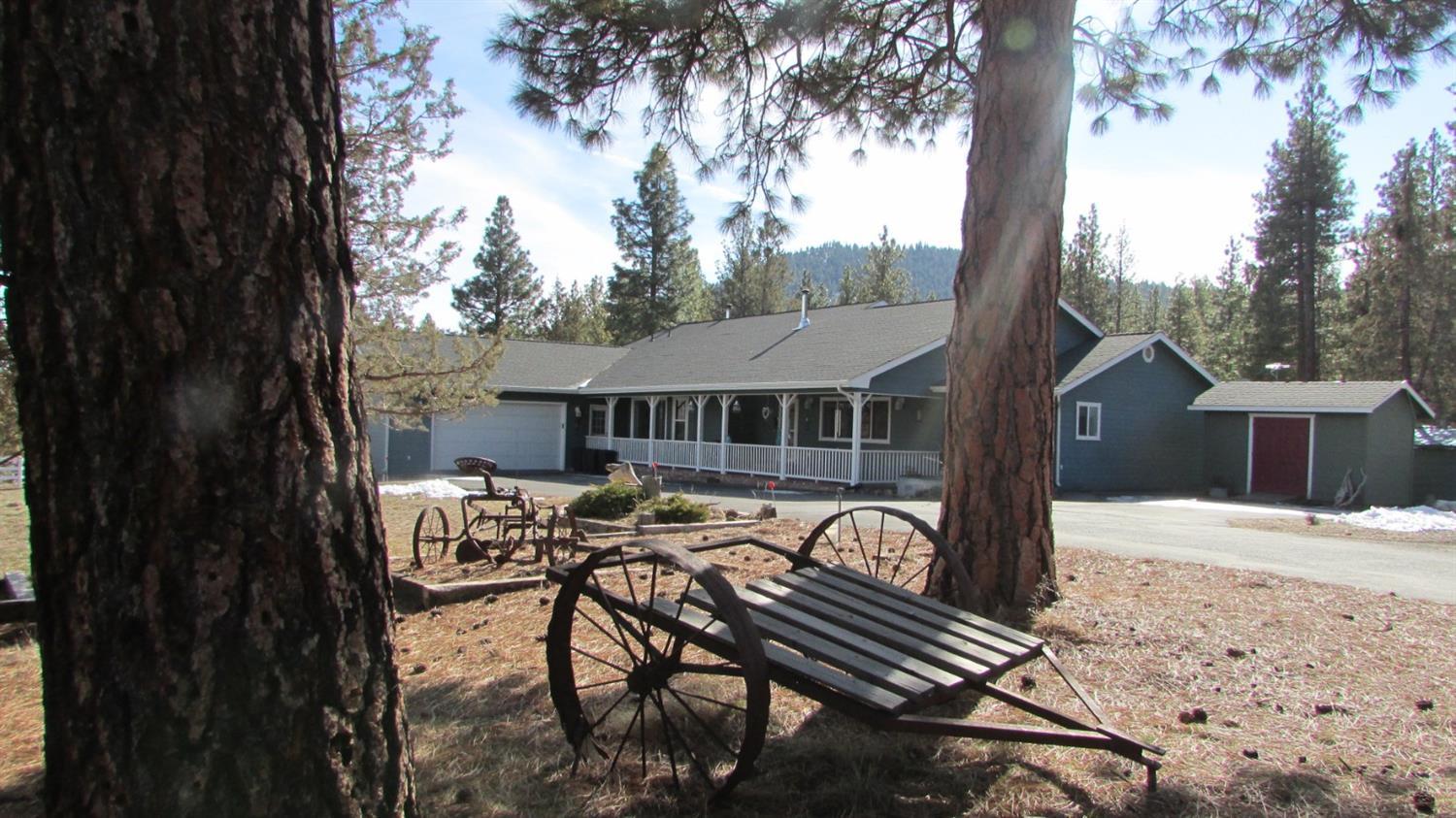 An escape from the ordinary. 5 picturesque fenced acres among the pines with a 2800 + square foot home that features 4 bedrooms, 2 baths, dining area, living room, family room, spectacular large master suite with an adjoining sitting area or office, garden window in the kitchen, ceiling fan in the master, plenty of storage, large 2-car garage, RV parking area with hookup, covered porch, large back deck to enjoy the mountains, sunsets and the night sky and located close to the wildlife refuge. This home is painted with sunshine. Come take a look.