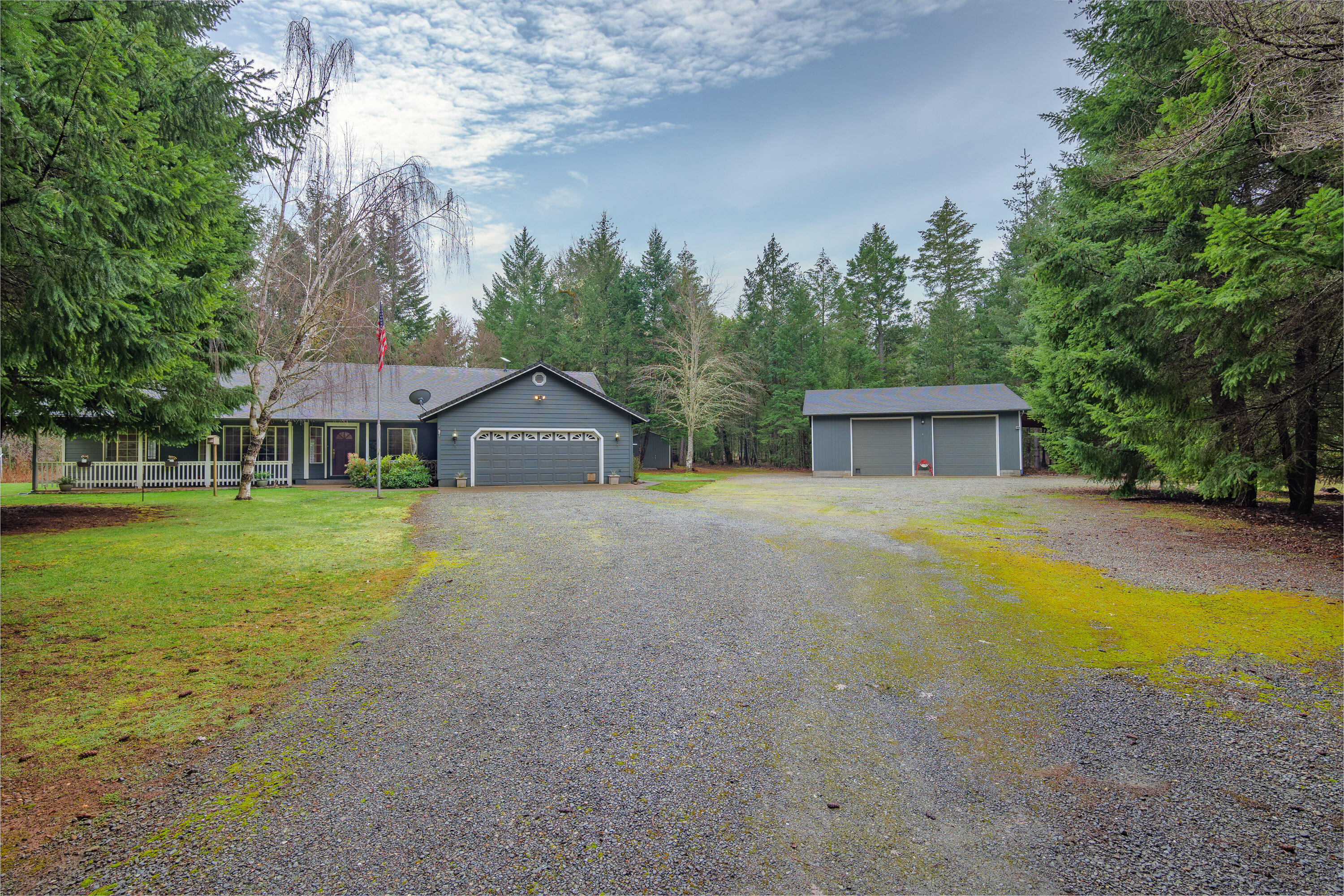 Don't miss this incredible Property.  2196 Sq ft home with 1600 Sqft Shop on 5 flat acres. House was build in 1998 by Admiral Construction. Home features vaulted ceilings, granite counters, stainless steel appliances and extra large pantry in the kitchen.  Living room with certified wood stove, family room and dining room.   Masters sports vaulted ceiling, patio door to brand new deck, oversized walk in closet plus private master bathroom.  2 additional bedrooms plus a den.  1600 Sqft Shop, 16' ceiling, 220 power, 2 roll up doors, air compressor and plumbed for bathroom.  640sqft RV Carport with electric hookup, attached to the shop.  Plus a  detached carport.  Gated Entrance, fenced, paved driveway and landscaped yard  surrounded by 5 lightly wood acres.  There are seven water spickets in the acreage with self draining pumps. A large garden area with seven different fruit trees, raspberry patch, an outside vegetable washing station. Seller will give an $8000 with Full price offer.