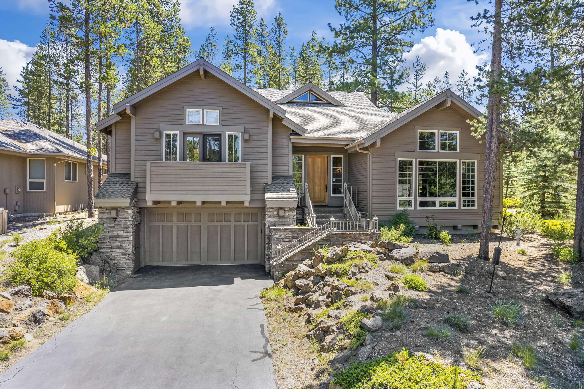 This beautiful well maintained home is tucked away in a quiet cul-de-sac and close to all the fun Sunriver has to offer. Madrone wood floors and spiral staircase along with the vaulted ceiling make a stunning entry. The open living floor plan is wonderful for entertaining. The living room features a floor to ceiling river rock fireplace and large windows with a peak-a-view of Mt. Bachelor. There is a den/office space perfect for working from home. The primary bedroom has a gas fireplace, roomy walk in closet, double vanities, soaking tub and large natural stone tile walk in shower. As you head to the second en-suite bedroom with double vanities and walk in closet, you pass the third bedroom, full bath and laundry room. A spacious backyard patio with hot tub and natural gas bbq is easily accessible from the kitchen, dining, den and bedroom areas. The two car garage has ample storage spaces and a built in workbench. Timeless design and quality throughout.