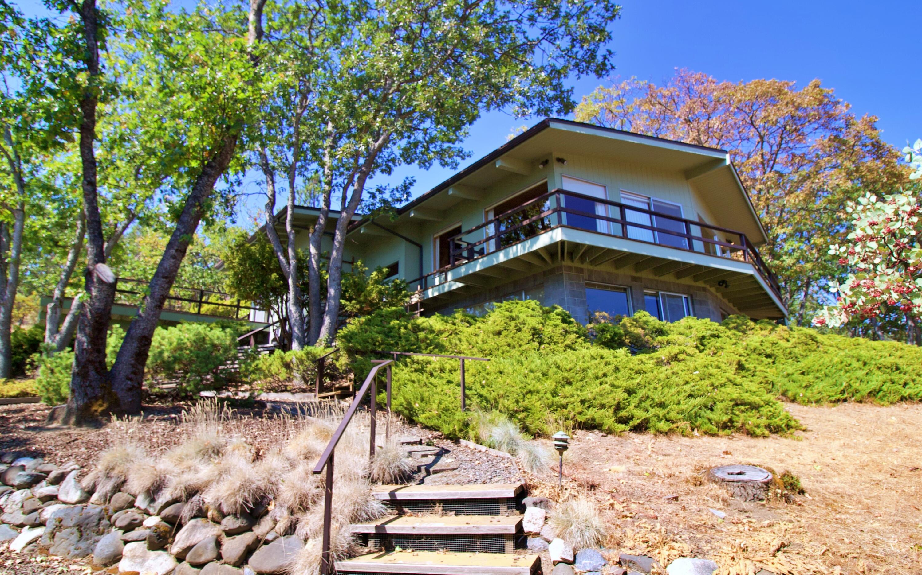 Check out the views in a super desirable location overlooking the rolling hills of Ashland! This beautiful estate was established in 1966  with 3 bed 2 full baths and 2524 total Sq ft!! The home is the last one on the road into a dead end so its private slice of paradise. The architecture of the home is unique as seen on the front photos. This house is move in ready and is a prestigious location in Southern Oregon. Ashland is home to Shakespeare, Independent Film Festival, and the world famous Lithia Park, Ashland's crown jewel with walking paths, duck ponds, Japanese Garden, Park Benches, Parking, Pickleball Courts, Picnic Areas, Playground, Restrooms,Volleyball and all kinds of activities during the summer! There is a work shop in the home and a office that overlooks the rolling hills around Ashland! Check out the walk thru video and Come take a tour TODAY!
