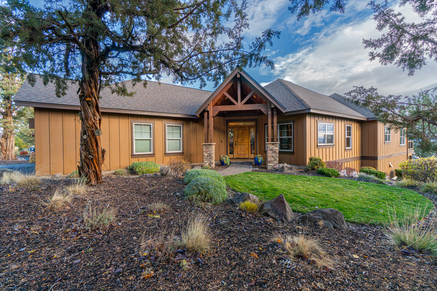 Enjoy panoramic views of Smith Rock and the Ochoco Mountains from this gorgeous home located in the Vista Rim neighborhood at Eagle Crest Resort! Great room floor plan featuring a vaulted ceiling, hardwood floors, solid core doors, wood-wrapped windows and trim, built-in entertainment center, and gas fireplace. The recently updated kitchen boasts new slab granite, sink, backsplash, and extended cabinetry, countertop, and floating shelves. New stainless Thermador dishwasher and gas range with griddle, and Bosch refrigerator. Primary suite on the main level with gas fireplace, tray ceiling, double-sink vanity, walk-in closet, soaking tub, and walk-in shower. Guest room, full bath, utility, and den with Murphy bed on the main level. Bonus room with built-in entertainment center and wet bar, guest room, full bath, and storage room on the lower level. Deck on main and patio on lower level with hot tub. New carpet in bedrooms and luxury vinyl in the bonus room. New roof in 2019