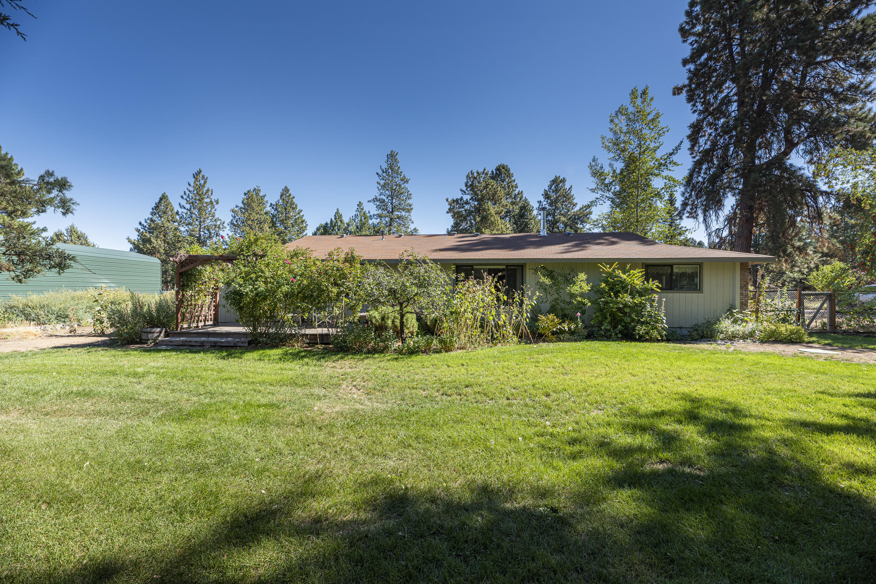 This home will go quickly! 3 bed, 2 bath, immaculate home on nearly 1/2 acre in Bend. Within minutes to shopping, restaurants and medical facilities yet feels very private. Large fenced backyard with a shed, workshop, greenhouse, toolshed, raised garden beds, fruit trees and berry bushes. You will fall in love with the brick entryway that also provides additional privacy. Schedule a showing soon before this rare property will not stay on the market long!