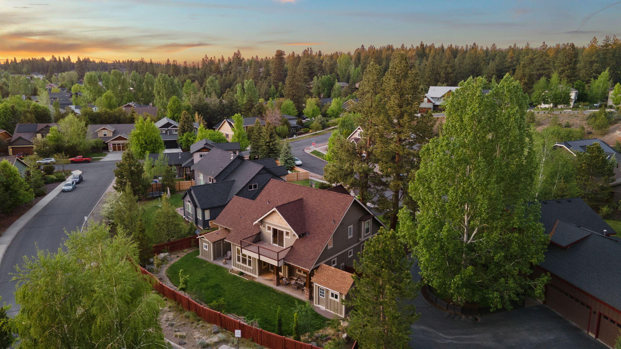 Tucked at the end of a quiet cul-de-sac in NW Bend, this Westside craftsman sits on a rare .23-acre lot with a sunny, level backyard that lives like its own outdoor room—ideal for gatherings, play, or peaceful mornings. With no direct rear neighbors, you'll enjoy added privacy and a sense of space that's hard to find. Just 0.9 miles to The Grove. New roof and interior paint in 2025. HVAC with humidifier, water heater w/ circulation pump, and exterior paint all updated in 2022. Inside, tall ceilings and great natural light shape a layout that lives easy—open living, walk-in pantry, central island, built-ins, and newer appliances flow straight to the covered patio. Upstairs, the expansive primary suite is a true retreat with lounge space, spa-style bath, and private balcony. A main-level office, oversized laundry/mudroom, and spacious garage support daily life. Out back: a finished studio for work, art, or wellness—and a bonus shed for your Bend gear.