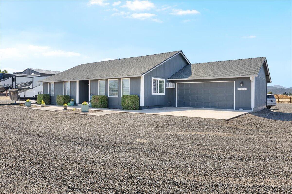 This picturesque 5-acre versatile property is designed for both enjoyment & functionality! The land features a fully insulated 40x60 shop equipped with heating/ A/C, full bath + washer/dryer & concrete floors with drainage system. Equestrian amenities include a 3-stall barn w/ tack room, livestock paddock, RV hookups, & a fenced pasture that captures sweeping panoramic views. The home has been beautifully updated with custom cabinetry, granite & marble countertops, brand new appliances & kitchen island w/breakfast bar. LED lighting, newer roof, upgraded flooring, on-demand water heater & whole-home water filtration. Outdoors, the grounds are designed for low-maintenance living with fire-resistant landscaping, a new covered back patio perfect for entertaining + 2 car garage and ample parking for all your vehicles, RV & toys. Chicken coop, covered parking for equipment + electric gates w/ keypad access add security. Don't miss all that this property has to offer!