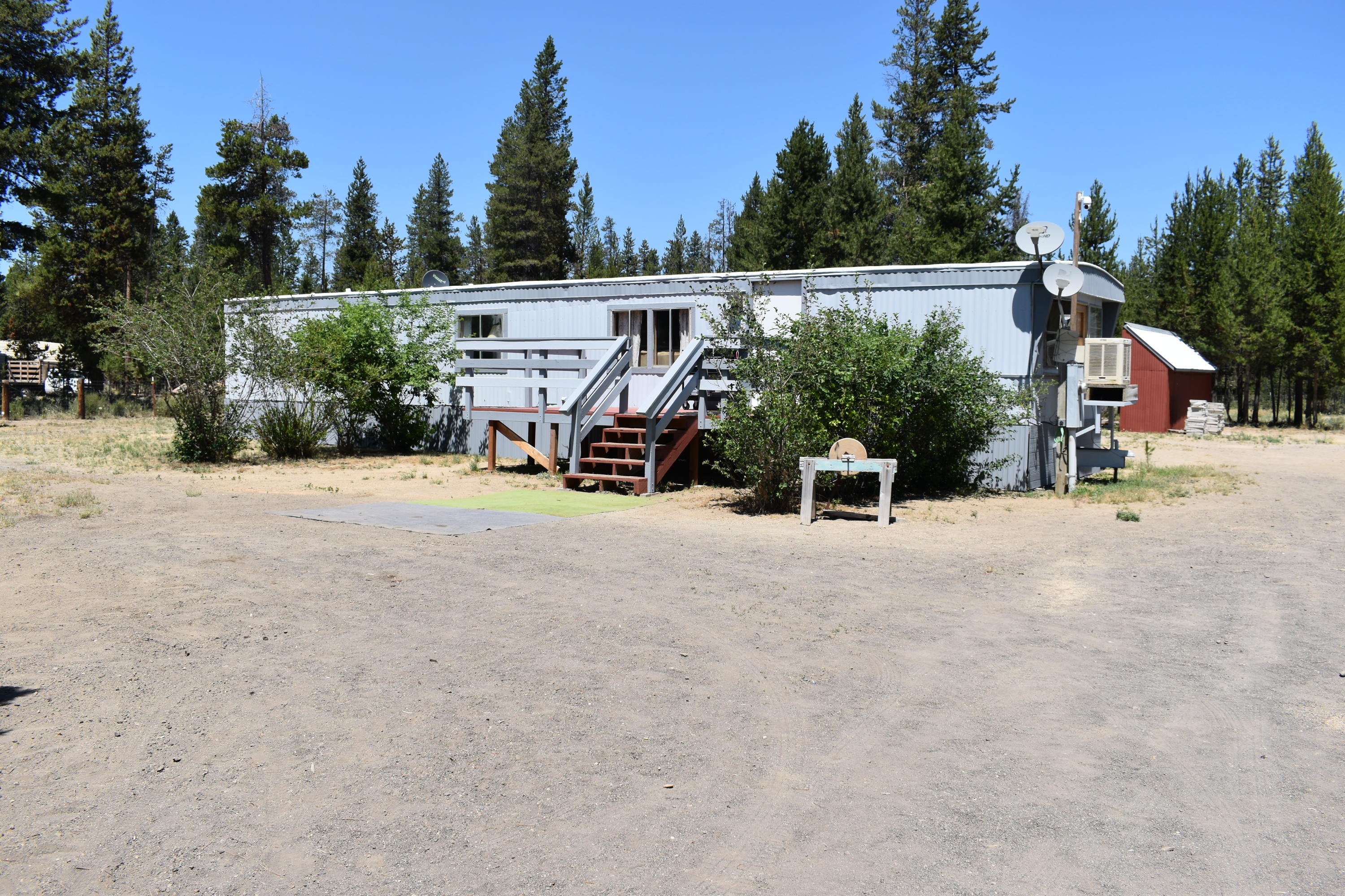 Don't let the age fool you!!  Consider this clean move in ready 1980 Single Wide 2 bed 1 bath that has been updated by the owner. Includes new flooring, new drywall, interior and exterior paint, and new front deck! Located off the Oregon Scenic Byway, in the Antelope Meadows development just 8 miles South from the City of La Pine! Country living at its best! Property includes fully fenced and gated 1 acre + or - (1) 10 x 20  barn shed, 2 poultry coops, 2 lien to's, green house! Very unique property!
