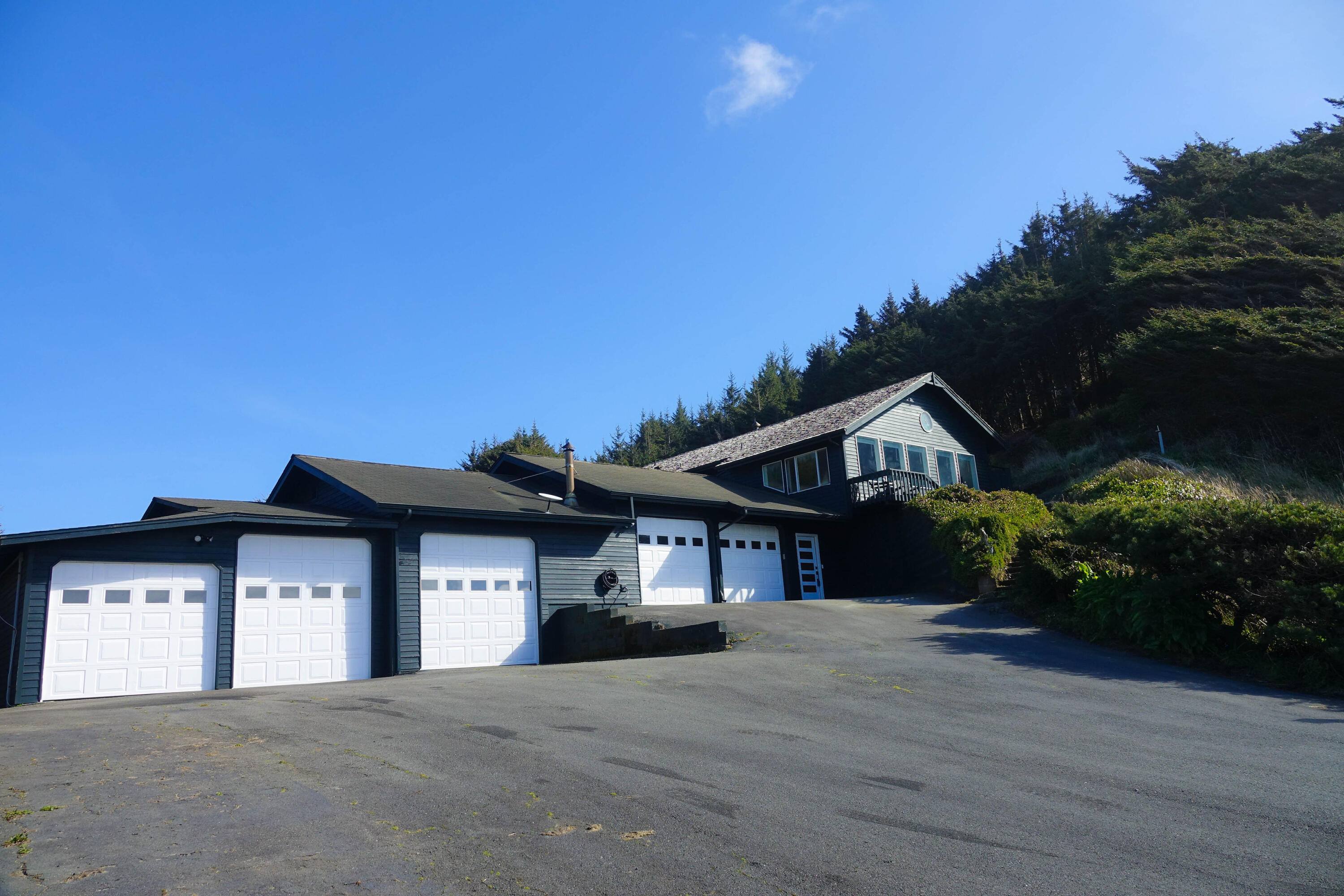 Rare & private oceanfront retreat on 1.86 acres! Just minutes from Bandon Dunes & the town of Bandon, this charming 3BDR/2.5BA beach house offers spectacular Pacific Ocean views & easy beach access from your own front yard. Recently updated with new carpet and lifeproof laminate flooring, the upstairs also features granite kitchen countertops, & large windows from the great room for whale watching and enjoying picturesque sunsets. Attached to the great room, a large deck leads you down to the private creekside backyard where water rights from a high flowing year round spring provide an excellent resource for all of your gardening endeavors. Downstairs with a separate entrance, you'll find the perfect 2BDR/1.5BA vacation rental or guests' quarters entrance that was previously used as a Bed & Breakfast. With 5 new vinyl garage doors, there is plenty of space to park your truck, boat, RV, or even create a workshop. Outside you will find a 24kw Generator and RV parking with power hookups.