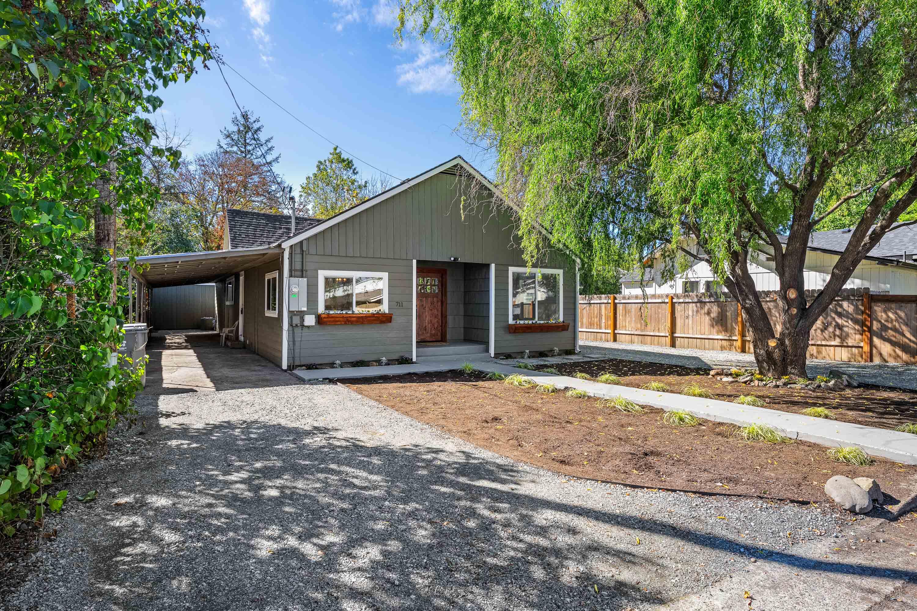 Completely transformed from top to bottom, this beautifully remodeled home offers modern finishes, thoughtful design, and unbeatable convenience just minutes from downtown. Step inside to an open, light filled layout featuring new flooring, fresh interior and exterior paint, and updated fixtures throughout. The stunning kitchen showcases custom soft close cabinetry, granite countertops, and SS appliances, creating the perfect space for cooking and entertaining. Both bathrooms have been tastefully remodeled with quality materials and a clean, modern aesthetic. The home's updates extend beyond the interior with a new roof, HVAC, and water heater providing long term peace of mind. Outside, a large outbuilding offers incredible versatility ideal for a workshop, storage, or hobby space. Situated on a quiet dead end street, the private yard provides ample room to garden, entertain, and relax. This move in ready property perfectly combines comfort, function, and style in one complete package