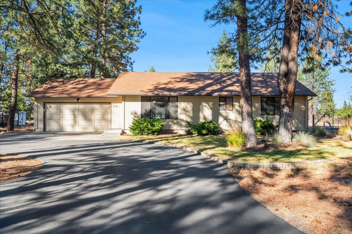 Discover this unassuming, impeccably clean single-level home in SW Bend, nestled among towering pine trees on a spacious lot. Short-term rental eligible, it's perfect for investors or homeowners seeking tranquility just 10 minutes from downtown. Inside, enjoy a thoughtful layout with brand new carpet throughout. Two inviting living rooms feature vaulted ceilings—one featuring hardwood oak floors. Set back from the road with a circular asphalt driveway, there's ample room for RV/toys parking. On the side of the home sits a garden area, and a freshly stained deck sits out back for outdoor gatherings and enjoyment. The garage includes built-in cabinets for organized storage.
Serene, functional, and ready for you!