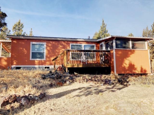 Looking for privacy, with still being close to town? This 1260 sq ft home with a large shop on 3+ acres is it. Lots of room for RV and toys. Open concept living with a large kitchen. Fenced in garden area with small green house. Subdivision has paved roads.