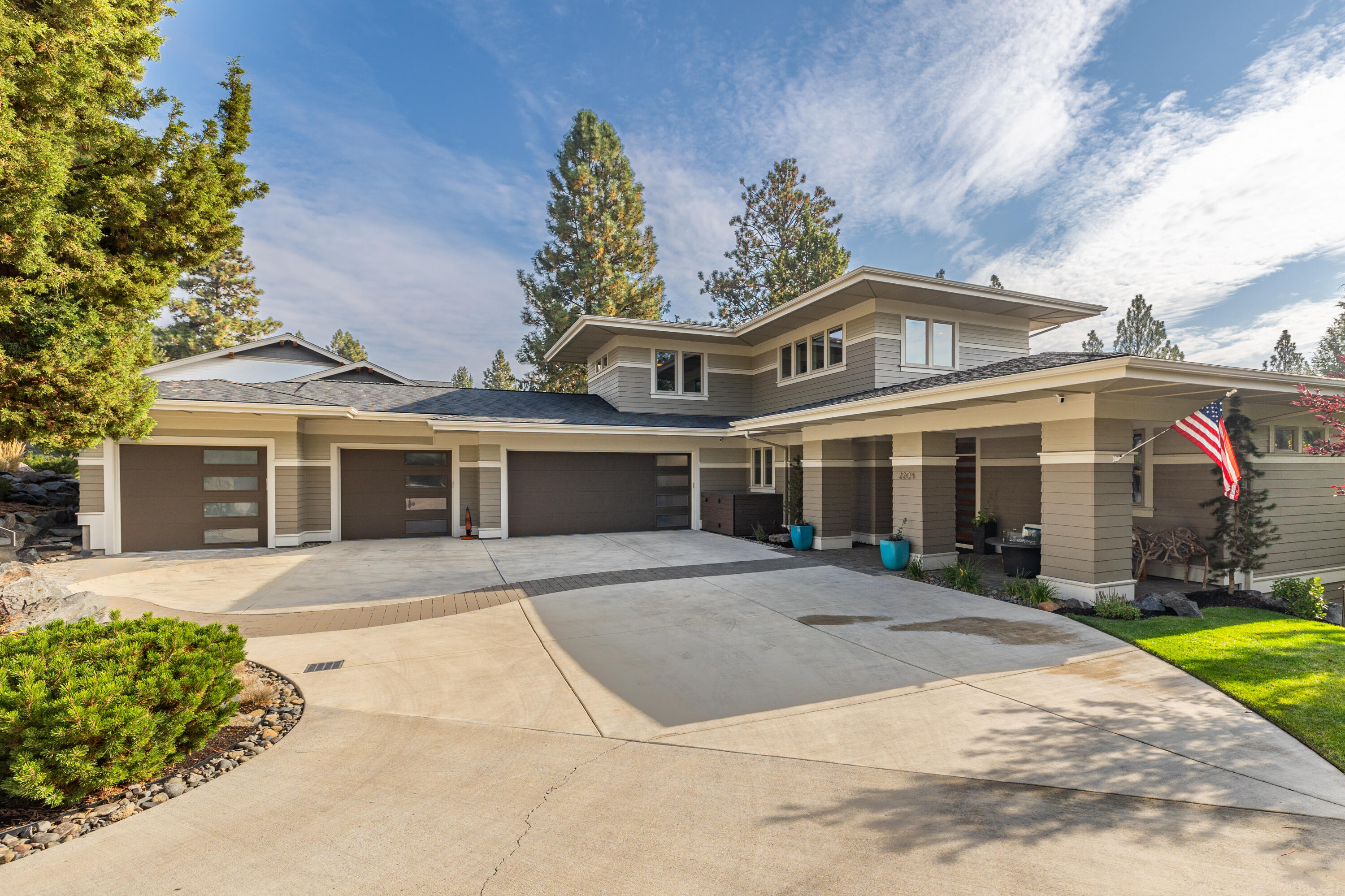 MOTIVATED SELLER!! Main Level Primary and 4 Car Garage! Stunning property in coveted NW Crossing! A luxurious modern home with many premium features.  On the main level, a large office, custom built in wet bar with wine storage and a kegerator and tap, sizable kitchen with beautiful appliances, spacious solid-surface counters, and stunning wood cabinets. Smart home features include the ability control music, lights, locks, and blinds from your phone/in-home iPad. Main-level primary suite includes a large bathroom with dual vanities, heated floors and a walk-in shower and walk-in closet with custom walnut built-ins. Built-in barbecue grill on the elevated back deck. Additional features include a RO water filtration in kitchen, built in air lines in the garage for a compressor and tools, extra full size fridge in garage, built in vacuum system and heated garage.