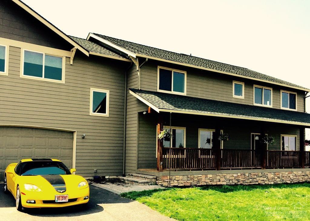 4535 SF custom home w/mtn views. Close to Bend, yet with a country feel. Huge water feature, heated paver patio w/fireplace, automated buried irrigation system, bass stocked pond, heated shop w/3-12ft doors. Sun room w/radiant heated floor & party kitchen, family kitchen/dining area w/hickory floors & large walk-in pantry, media room w/projection screen, living room w/propane fireplace & 6 floor to ceiling windows, office w/built-in desks & family room. Master bedroom w/bath & heated floors & tiled shower.
