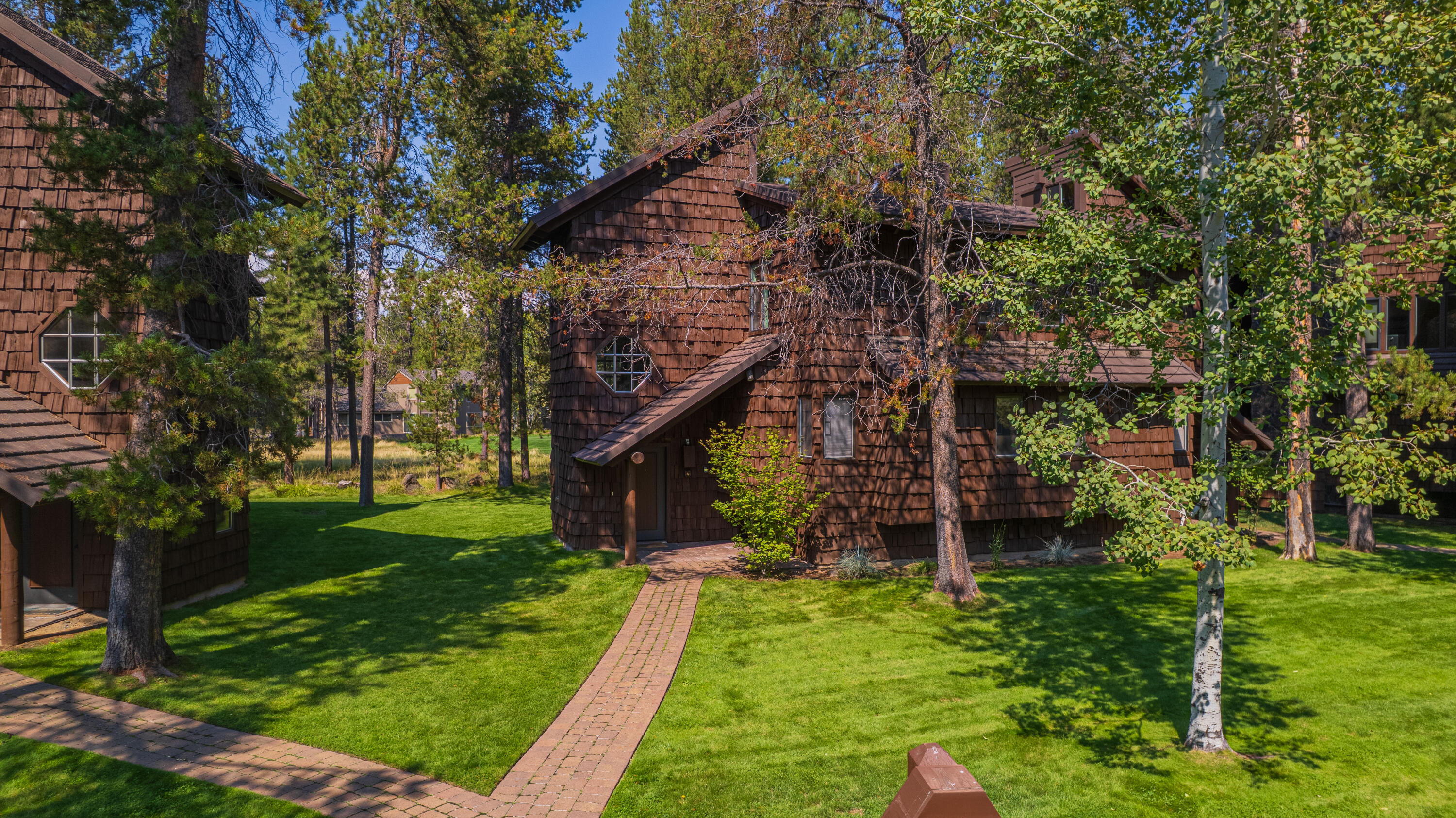 This updated Wildflower condo captures the essence of Sunriver living. Set along the Meadows Golf Course, it offers peaceful, tree-lined views from two private decks and easy access to The Village, The Lodge, The Cove, and Sage Springs Spa. Inside, the multi-level plan has been tastefully remodeled with a light, modern kitchen featuring updated cabinetry, counters, and appliances, plus refreshed baths with new vanities and fixtures. Two bedrooms, two full baths, and two lava-rock gas fireplaces create inviting spaces for gathering and relaxation. Additional updates include a highly efficient heat pump/AC with programable thermostat, new flooring, lighting, window coverings, and furnishings. Offered fully furnished, this Wildflower condo blends comfort, convenience, and classic Sunriver charm—an ideal retreat or investment.