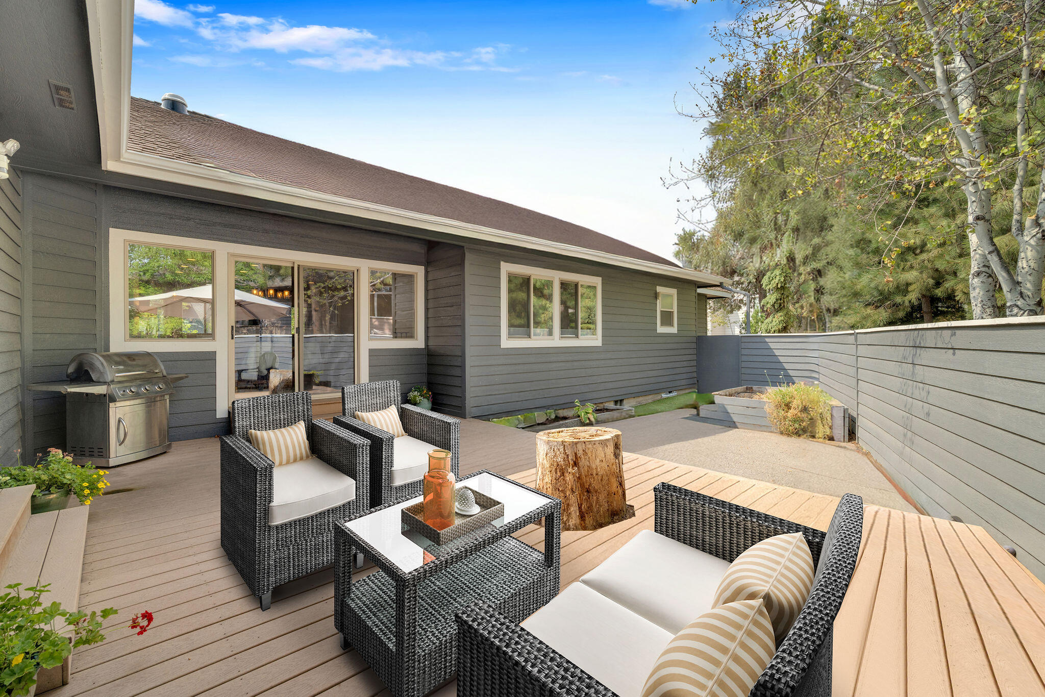 Turn-key Westside Bend living- move in, unpack, and enjoy from day one! This single-level, 3 bed, 2.5 bath home sits on a sun-filled 0.28-acre corner lot with a fully fenced yard, delivering privacy, space, and low-stress living in one of the most sought-after areas of Bend. The 3-car garage adds a rare Westside convenience. Vaulted ceilings, bright spaces, and hardwood flooring highlight the open, functional layout. The spacious great room features a gas fireplace and flows into a chef's kitchen with quartz countertops, high-end appliances, breakfast bar, and large island with gas range. The primary suite includes a sitting area, jetted tub, and direct access to the private and sunny backyard. Enjoy both morning and afternoon sun from the Trex deck and patio, perfect for outdoor relaxing or hosting.  Close to parks, trails, and restaurants, this move-in ready home offers the location, comfort, and ease - no projects, no delays, just effortless Westside living.