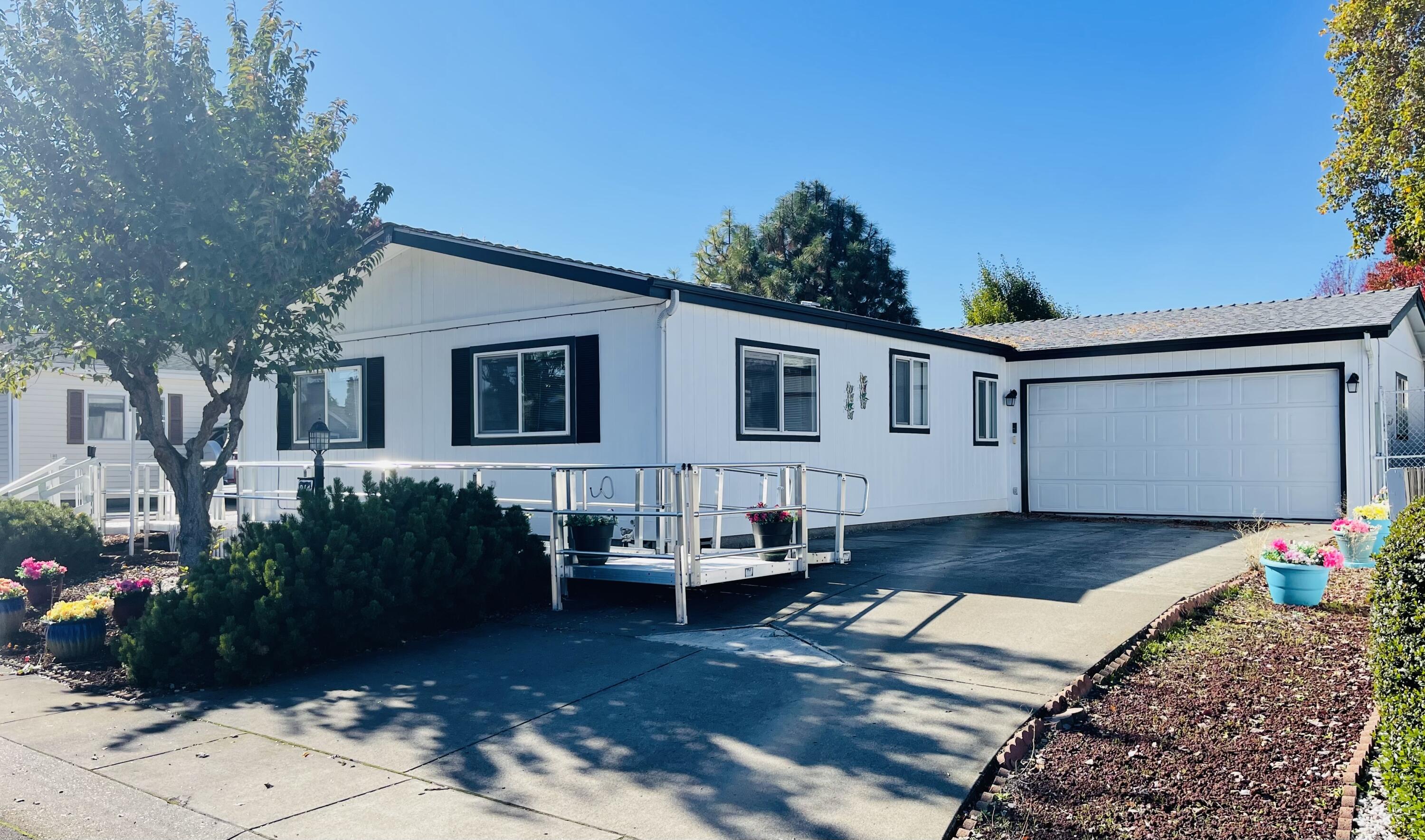 This cozy 2 bedroom, 2 bathroom manufactured home is located in the popular 55+ community The Meadows. Open living space, office/desk area, large laundry room, covered patio, 2 garden sheds (1 w/power), tons of storage in the garage and throughout the home. Privately owned lots in this park so there is no monthly space rent. Clubhouse, pool, and gym are just a few of the great amenities this community has to offer.