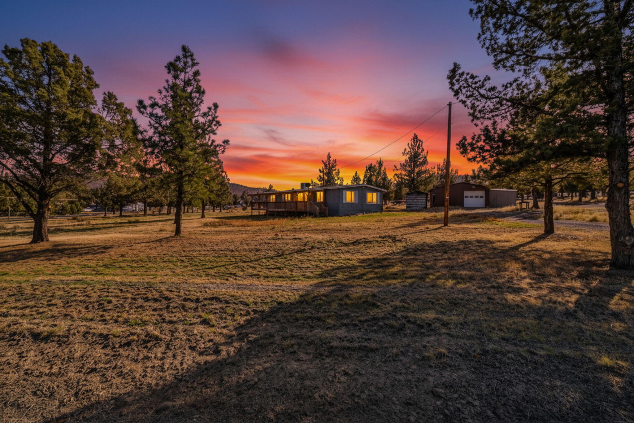 Beautifully updated 3 bedroom, 2 bathroom home on 1.9 acres in the Highlands Subdivision. Enjoy all the perks of a quiet, established neighborhood, it's even on a corner lot! Step inside to discover fresh interior and exterior paint, new carpet, and vinyl flooring, and a recently resealed roof for added peace of mind. The home also features 2 ovens, a new electric water heater, updated plumbing under the home, and electric forced air heating plus a roof mounted swamp cooler to keep you comfortable year round. Outside, you'll find outbuildings, including a 1 car garage with an attached workshop equipped with 220 power - perfect for hobbies, storage, or a home based business. With community water, ample space to roam, and the rare combination of rural privacy and neighborhood charm, this move in ready property won't last long! Property is grandfathered in and not in the POA.