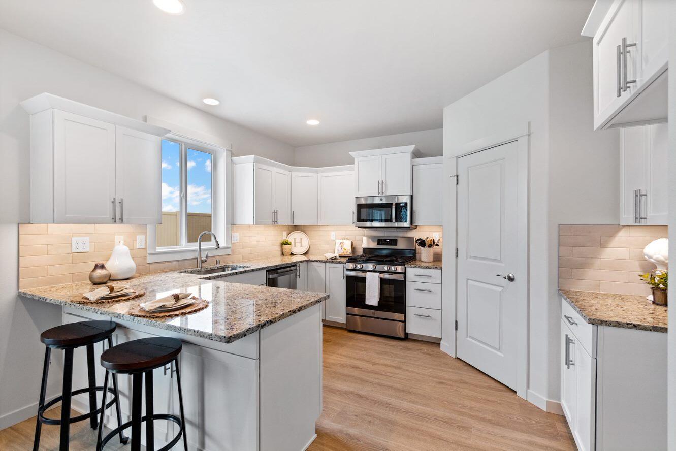At 2211 square feet, The Timberline is the perfect home for those in search of a brand-new home that offers space and versatility in a two-story plan. The living and dining rooms share an impressive space overlooked by the open kitchen which features ample counter space, cupboard storage and a large pantry. Lower level offers an additional flex room with a full bathroom. Upstairs, the expansive main bedroom suite features an oversized closet plus second closet and deluxe ensuite bath including soaking tub and dual vanity. The other three bedrooms are substantially sized with generous closets and share a central bathroom – with a dual vanity. The Timberline new home plan is the perfect mixture of a smart design and a stylish package. Located on a larger and private homesite that backs a common space of the adjoining community. This homesite features two stunning & mature pine trees to canopy this beautiful & very special backyard space.