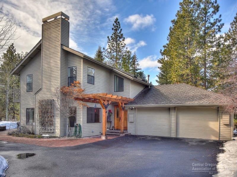 Welcome to this light and bright custom home on a large private lot in the desirable gated community of Sunrise Village! The South facing sun room is a true asset with multiple windows highlighting the large paver patio with built in benches, gas fireplace, and mature landscaping. Upgraded finishes inside and out including tall vaulted ceilings upstairs, 8 skylights, and private balconies. Neighborhood amenities include tennis courts, swimming pool, clubhouse, and access to the Deschutes River.