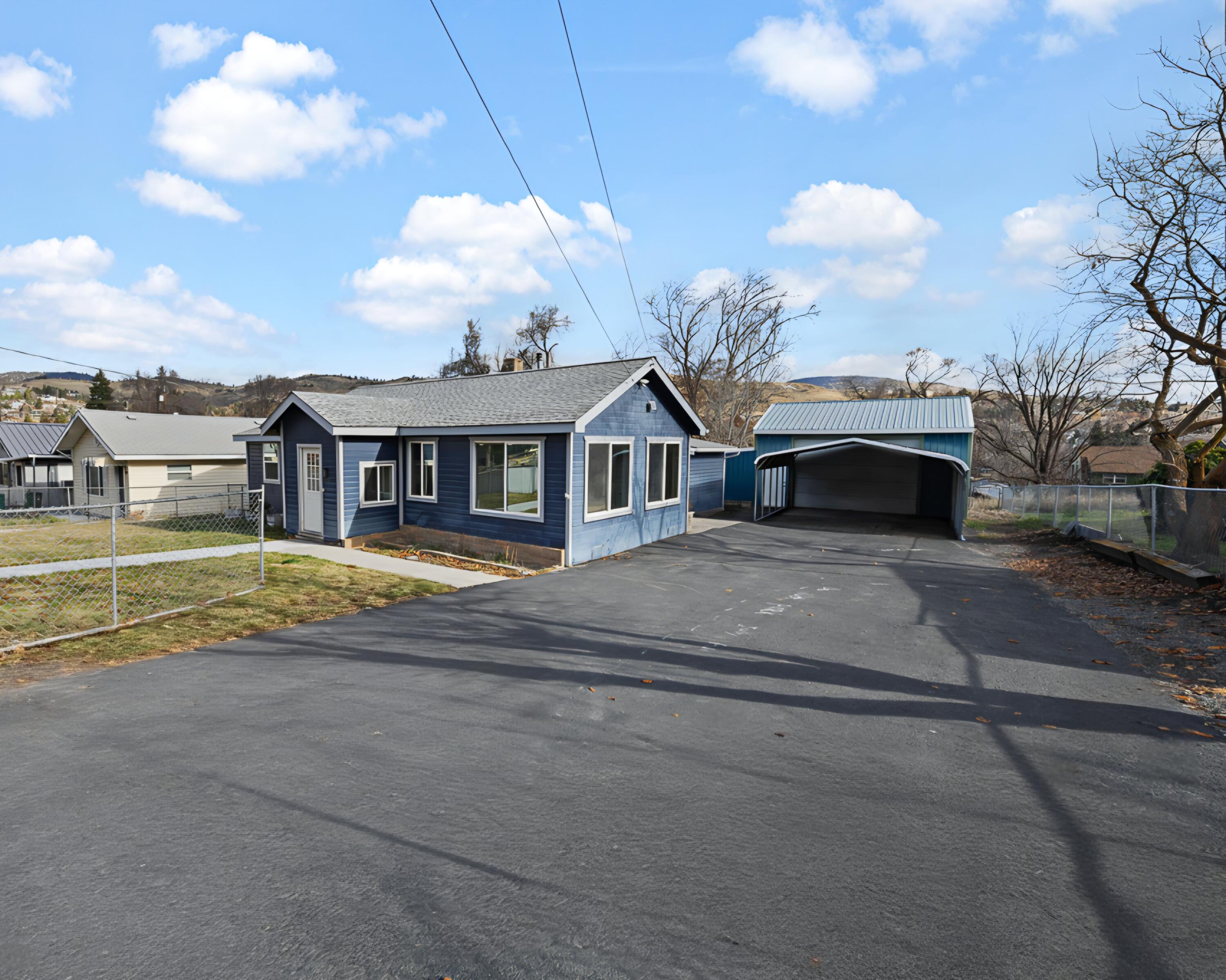 Welcome to this 3 bedroom 2 bathroom home that's comfortable, versatile and checks all the boxes. The layout has a smooth flow, with a bright main living area, a kitchen with storage galore, and the potential for 2 primary suites located on separate sides of the home. The living room will be your favorite place with vaulted ceilings, tons of space, and a pellet stove to  set the mood and keep you toasty warm. The large laundry room encloses an updated tankless water heater, and newer furnace and the main living spaces have brand new laminate flooring and paint. This place has all the extras including a hidden room with a safe, large carport, expansive shop, tons of parking, gated driveway, and more. This home has been meticulously cared for and is on the market for the first time since 1985, so don't miss this rare opportunity to be the next loving owner!