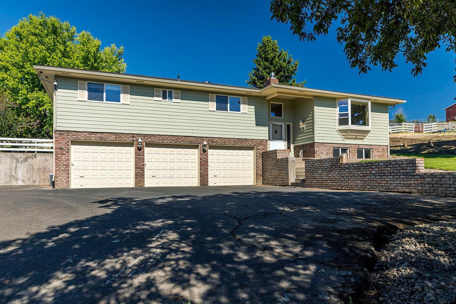 Beautiful well built home close to town, yet in the country! Featuring 2,700 sq.ft. +/- living space, 3 bedrooms, 3 baths, plus a big rec room and a den/ office downstairs. All with gas heat & A/C. Country kitchen with garden window, eating bar, tiled counters, & bay window with seat, in dining room and the living room to enjoy the gorgeous mountain views and cozy gas fireplace. All on 2.93 fenced acres with an incredible 48x41 HEATED SHOP with 12' door . Also has 110 & 220v power, bath, plus RV bay with full hook ups, and a barn for animals. 3 car garage and tons of storage. Upgrades include vinyl windows, composition roof only 2 years old, new exterior paint of home and shop. Lovely covered patio and nice mature landscaping and raised bed gardens.