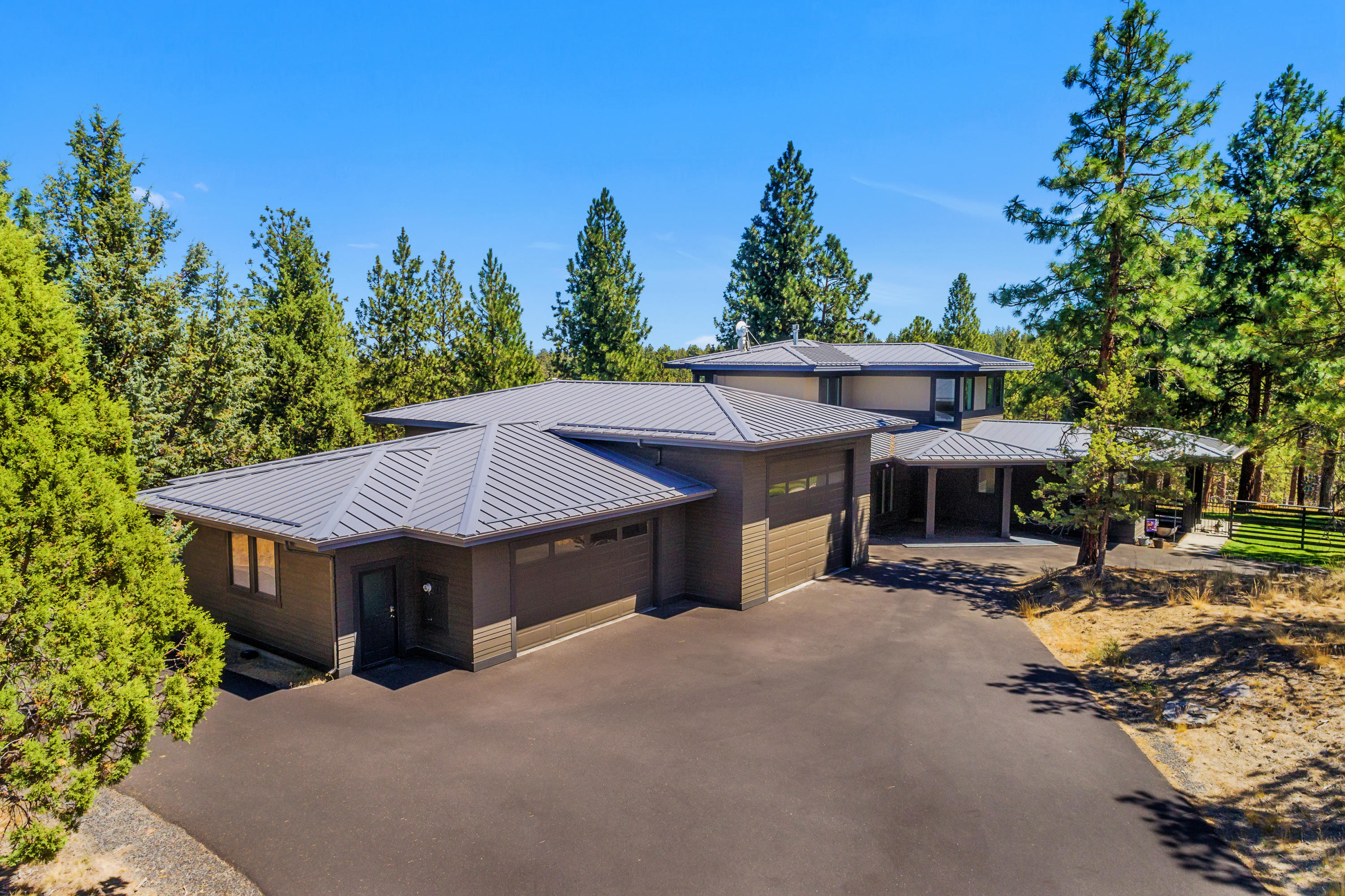Newer custom home on over 8 acres bordering Bend's coveted Shevlin Park. Stunning NW contemporary design featuring main level living and a 2,000 sf pull through RV garage. With ample natural light and views of towering pines, the interior setting is nothing short of impressive. The spacious kitchen boasts high end appliances, granite
countertops, a built in refrigerator, custom knotty alder cabinets, and a spacious walk in pantry. The main level master includes a sizable walk in closet, heated bath floors
and a steam shower. Let's not forget the climate controlled wine cellar, theatre room complete with surround sound, tankless hot water heater, the list goes on! Not to be
missed, there is an additional 864sf private office/flex space that has its own separate driveway entrance. All this in a peaceful and private setting just minutes from town.
This is truly what the bend lifestyle is all about!