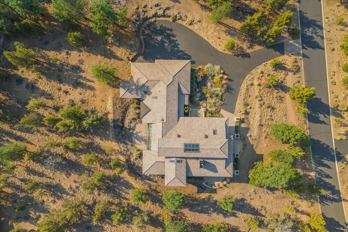NEW PHOTOS! An opportunity to own in North Rim for under $2M. Over 4500 Sq. Ft. of elegance and remarkable construction, designed to display your life of achievements expressed through your art, your creativity and your passion. Built in 2017, this single level home sits on a flat 1 acre offering a 3 car garage & breathtaking architecture.  Located in the gated North Rim community of Bend, OR offering walking trails, pickle ball and a community lodge. A spectacular double portico greets you at the front door where you get your first glimpse of the impressive scale w/ marble tile and Hickory hdwd floor inlay. Each room displays abundant windows and offers intimate function. The 30' ceilings allow the eye to wander far and wide through the many details highlighted by custom stained glass art pieces and strategic art lighting. Huge windows and double glass French doors throughout. A Must See! BEST VALUE.
