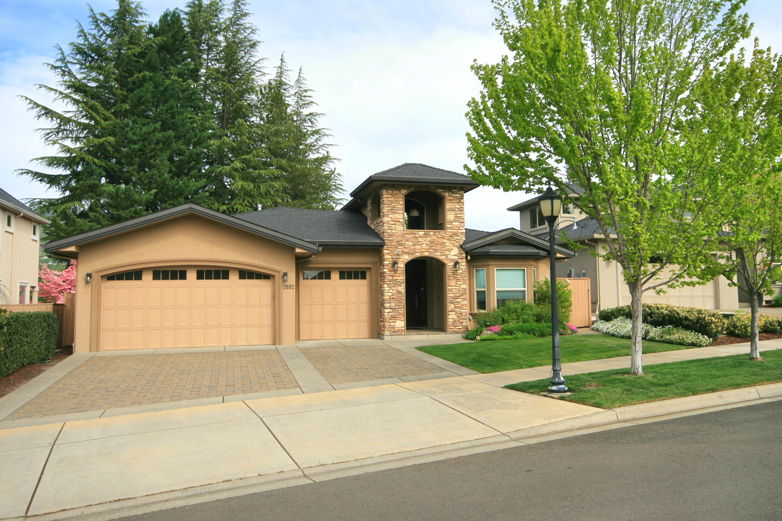 Elegant East Medford Home! Built in 2013, this contemporary style, single level home offers ease & comfort. 2062 sq.ft. of living space, 3 bds, 2.5 upscale bathrooms, vaulted ceilings and an impressive entry w/ soaring ceiling, natural light & flooring of wood & tile. Gourmet kitchen w/ walk-in pantry, granite counters, large island, stainless steel appliances, gas cooktop & comfortable eating area. Open to the living space offering the comfort of the gas fireplace insert w/ warm hardwood flooring throughout. Master suite w/ coffered ceiling & sliding glass door leading to easy access for the back yard spa. Spacious master bath includes soaking tub, granite double sink, walk-in tile shower & large walk-in closet. Guest bedroom and a third room suitable for bedroom or office share a modern ''Jack & Jill bathroom. Nice size laundry room w/ direct access to the oversized and finished 3 car garage. Fully fenced back yard w/ stamped concrete patio                 & beautiful landscaping.