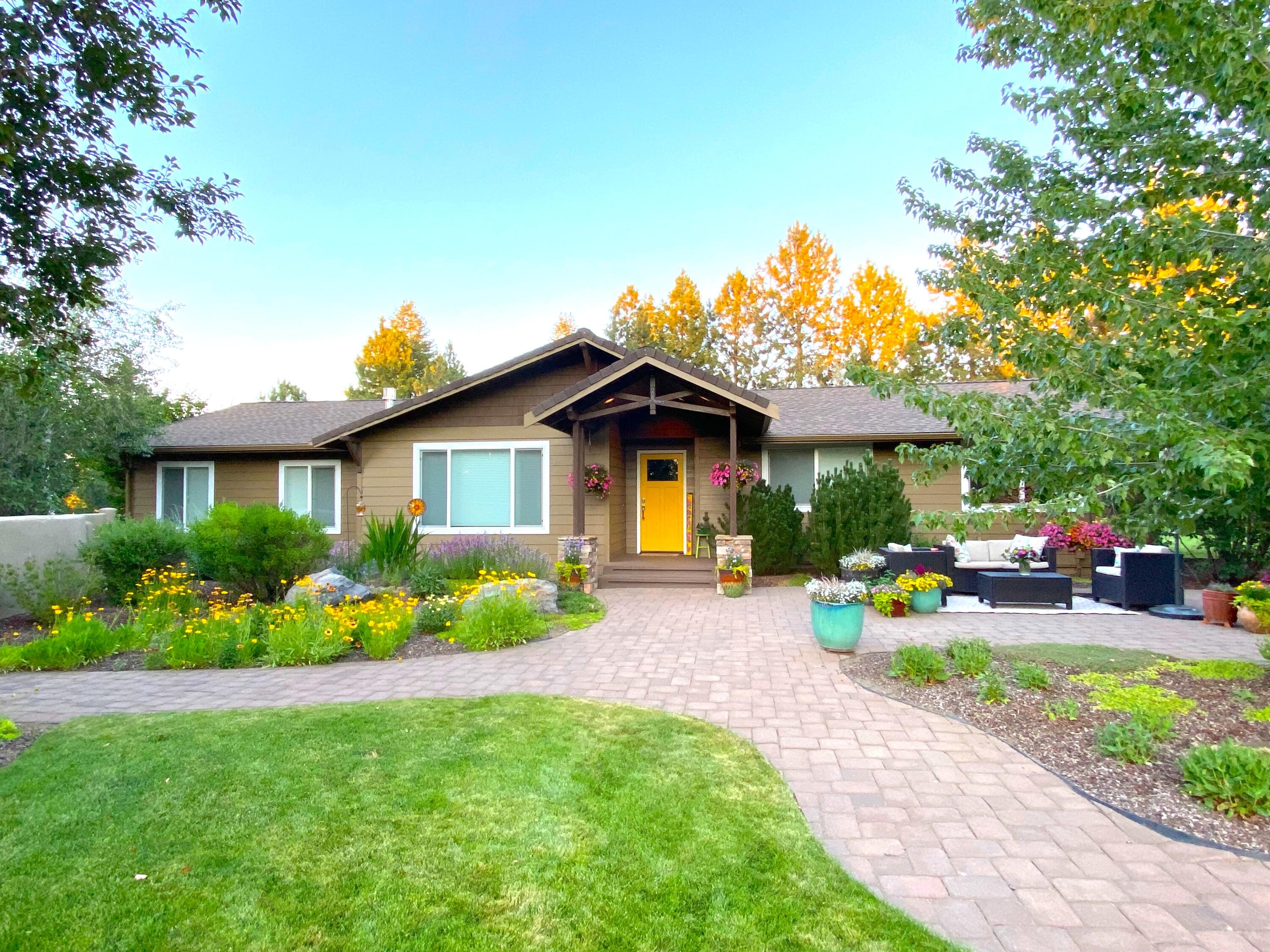 Gardening lovers paradise! This truly unique property on 1.19 private acres is close to town with a park-like setting that is beautifully landscaped and fully fenced with .93 acres of COID irrigation. A raised vegetable bed area is fully fenced and deer proof. There is a gated, walled courtyard entrance and a 250sf detached ''she shed'' (currently used as an art studio) w/ electricity and styled to match the house. Remodeled down to the studs in 2009/2010, this 3 bedroom, 2 bath beautifully designed home has an open floor plan with lots of natural light, hardwood and travertine flooring, slab granite countertops, stainless steel appliances, horizontal grain beech cabinets, and a propane fireplace. Plenty of space for indoor/outdoor entertaining with paver patio areas in front and back. There is also a 1,161sf detached 4-car garage w/ extensive built in cabinetry and level/gated parking area for RV/boat storage. This home has been meticulously maintained and is completely move in ready.