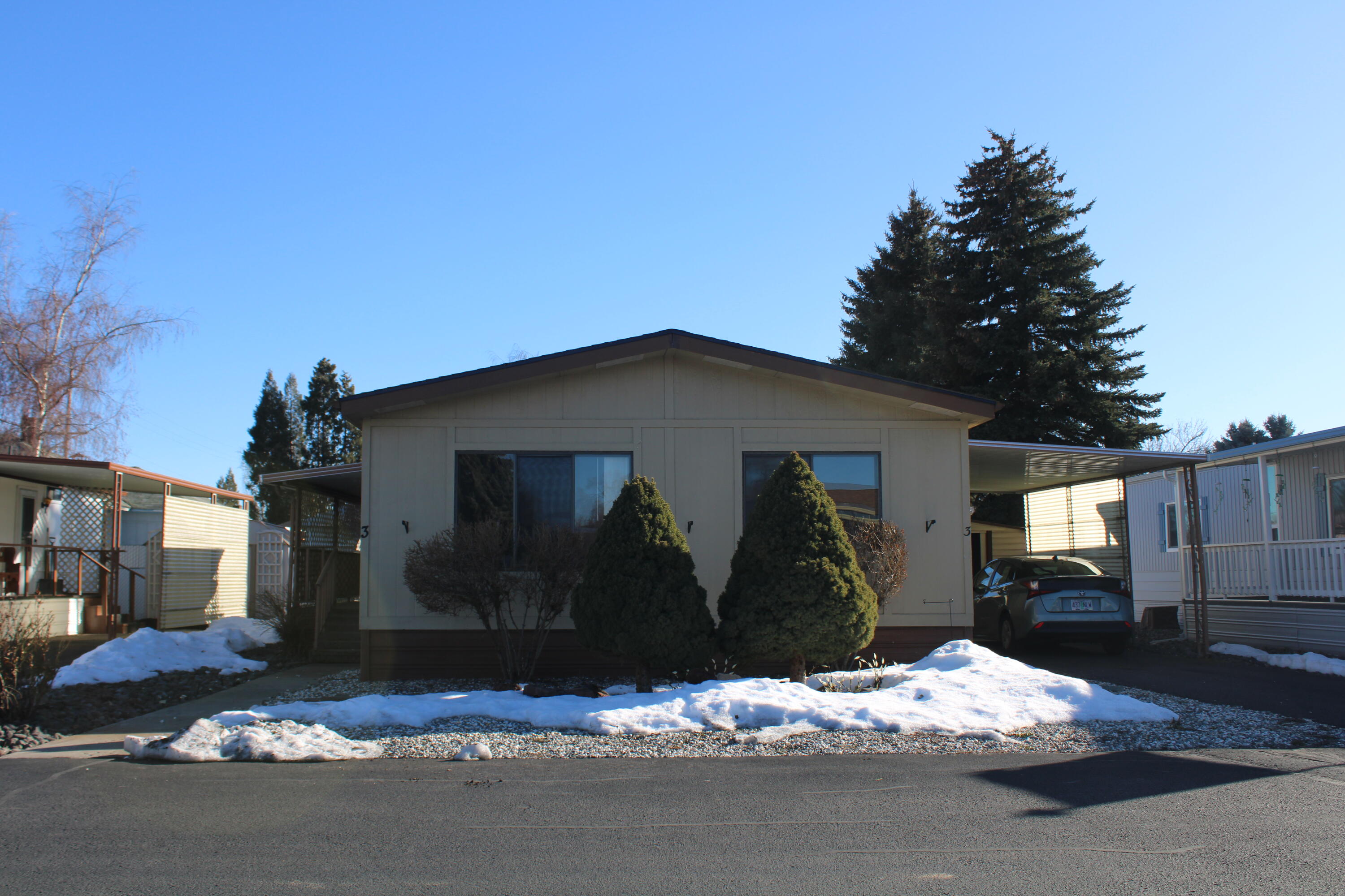 This lovely two-bedroom, one-bath manufactured home features vinyl plank flooring throughout, making it easy to clean and maintain. It has a spacious deck where you can enjoy the outdoors. For added convenience, there is an attached carport to protect your vehicle from the elements. You will also find two metal storage sheds on the property, providing extra space for your belongings. The roof was recently replaced just over a year ago. This home is in a 55+ park; the monthly space rent is $500, which includes water, sewer, garbage, and snow removal.