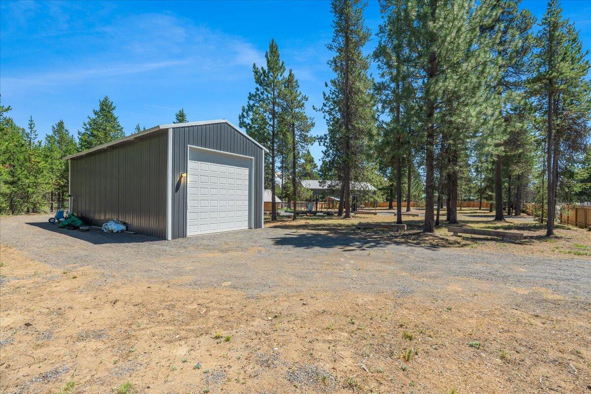 One acre buildable lot with 960 square foot shop, RV Cover, and carport.  Separate utility building for additional storage. This building has a separate fenced yard, and patio is hot tub ready. Fully fenced with multiple gates provide drive through access to the property and shop. Continue use as a recreational property or build your dream home here. Great property places you near Rivers, Lakes, and all the outdoor lifestyle Central Oregon offers.