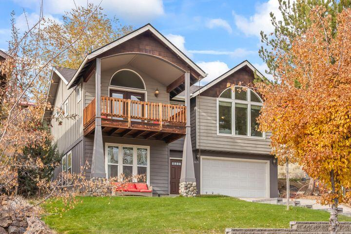 Beautifully crafted Craftsman-style home designed for reverse living to capture stunning views of Barnes Butte. The upper level features an open great room floor plan with vaulted ceilings, custom hardwood floors, propane fireplace, and large kitchen. The spacious primary suite includes a luxurious bath and a private large timbered front deck, overlooking Barnes Butte. Downstairs offers two bedrooms, a full bath, utility room, and convenient garage access. Enjoy a private, generous-sized backyard, handsome exterior elevation, and move-in ready condition. Just moments from the Barnes Butte Trail System, with miles of paved paths and access to hike the Butte itself. Enjoy all the outdoor activities Central Oregon has to offer, while living in the charming town of Prineville. This home perfectly blends Craftsman charm, thoughtful design, and Pacific Northwest Style all-in-one.