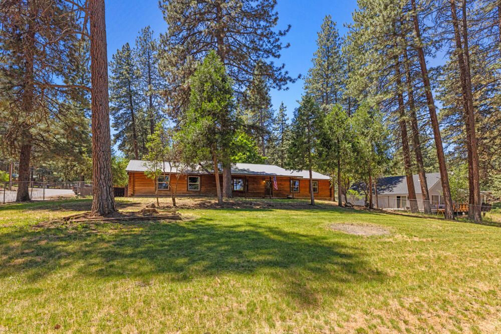 Welcome to your dream log home in Keno! This recently remodeled ranch-style gem offers the perfect blend of rustic charm and modern comfort. Nestled on a nicely treed lot, the fully fenced and landscaped yard provides privacy and a serene outdoor space. The primary bedroom features an attached newly remodeled bathroom for your convenience. Enjoy relaxing evenings in the backyard with a shed that includes a hot tub, perfect for unwinding. The spacious 2-car garage offers an attached pantry for storage needs. Inside, you'll find newer kitchen cabinets, brand new flooring & paint throughout plus new vinyl windows and sliding glass door that enhance energy efficiency. A newer gas furnace and wood stove ensures cozy winters. New ceiling fans and remodeled bathrooms. Metal roof. All appliances included -Move in Ready! Don't miss out on this updated home that captures the essence of country living with contemporary upgrades.