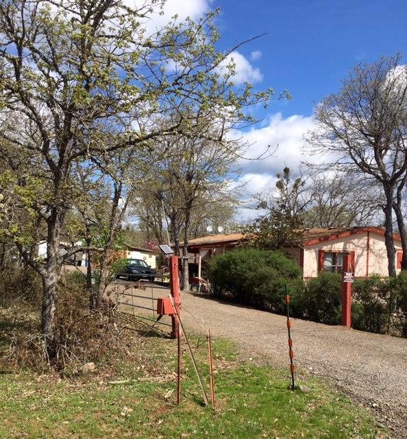 Beautiful Eagle Point acreage. This 3 bedroom, 2 bath 1344 square foot double wide manufactured home rests on 9.62 level acres. Built in 1991, it has a one car detached garage and is surrounded by mature oak trees.