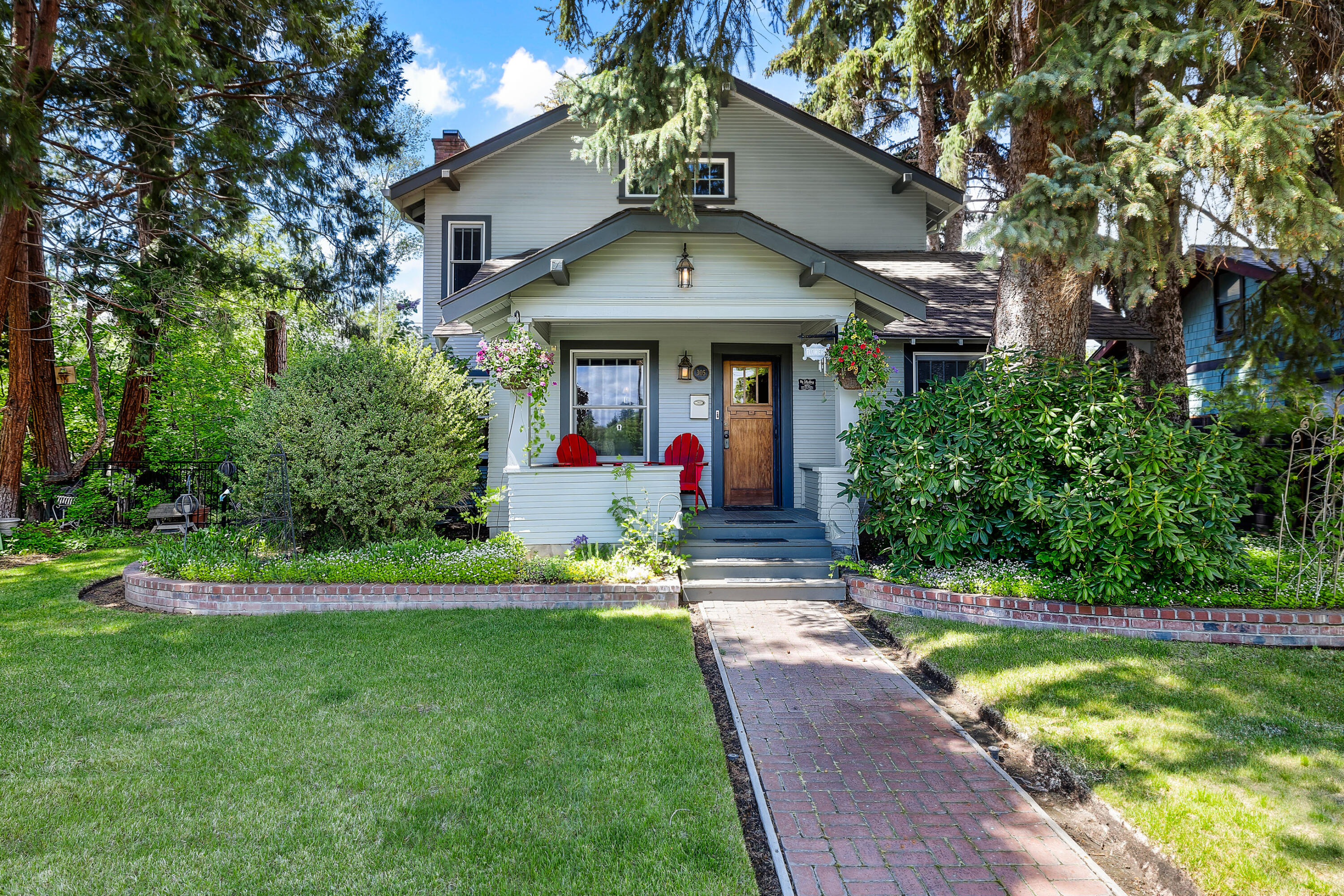Welcome to a rare gem nestled in one of Bend's most sought-after locations—just steps from the Deschutes River, iconic Drake Park and the Galveston and Old Mill Districts. This historic Craftsman home blends timeless character with modern comforts. With 4 bedrooms & 3.5 baths, this home features original fir floors and doors, period lighting, and handcrafted hardware that honor its early 20th-century roots. The home is framed by the oldest cedar grove in Bend, offering privacy and natural beauty in a walkable, urban setting. The living room features a wood burning fireplace which leads into the dining area with built in espresso machine. The kitchen features a gas cooktop, subzero refrigerator, and granite countertops. The spacious primary suite is a retreat, complete with a soaking tub and ample room to unwind. Whether you're hosting in the warm living spaces or enjoying quiet mornings among towering cedars, this special property offers a unique opportunity to own a piece of history!