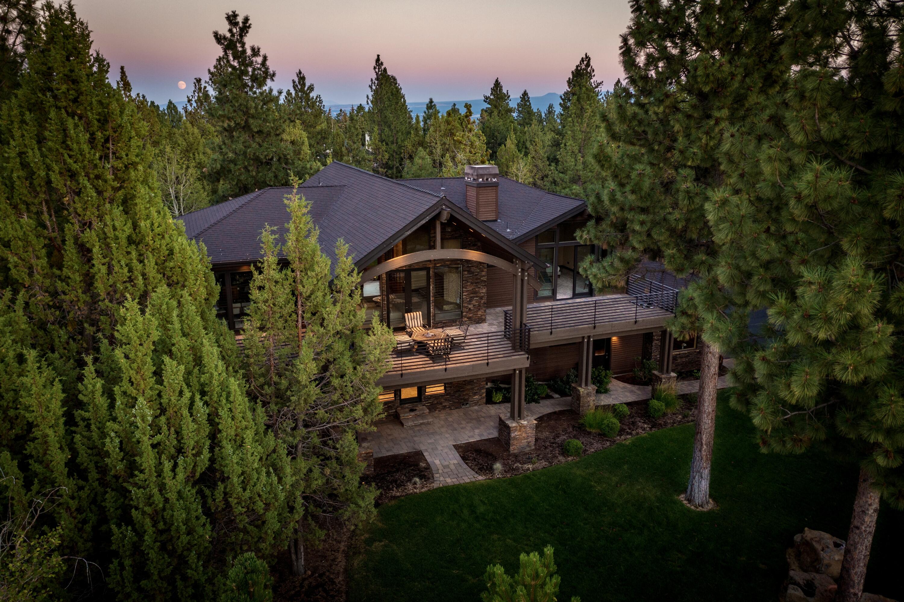 Timeless architectural beauty on Awbrey Butte. Enjoy gorgeous sunsets and Cascade Mountain views! Expansive 1.5-acre flat lot with immaculate landscaping, walkways and water features. Awe-inspiring two-story glass + stone entry leads up to vaulted great room. Spacious yet warm w/hardwoods, fireplace, chef's kitchen, oversize island and huge pantry. XL paver decks with views off multiple rooms creates seamless indoor-outdoor living and entertaining. Main floor STUNNING Primary suite w/walk in closet, fireplace, gorgeous bath, and doors out to deck. Downstairs lower-level features bonus room w/wet bar + doors out to park like yard and patio. Additionally: 3 guest bedrooms (2 ensuite) + another full bathroom, den/office and laundry. Heated 3 car garage w/epoxy floors + EV outlet + central vac. Incredible all-season property: Amazing in summer & Perfect in winter with spacious interiors and cozy fireplaces. All items in home included. Super low property taxes! See attached features list!