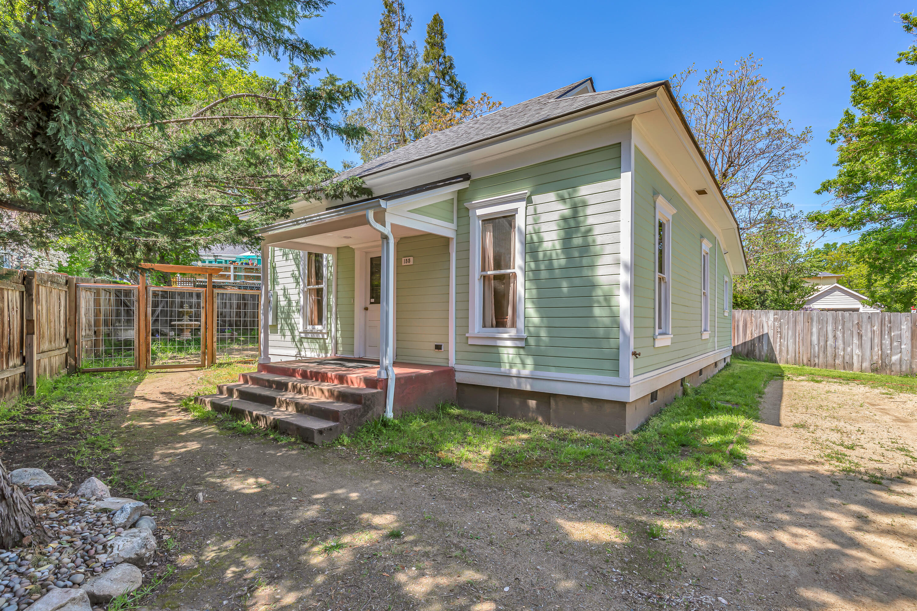 Fully renovated historic home and detached cottage on a corner lot with alley access in the Skidmore Academy Historic District - just three blocks from Ashland's downtown plaza or one block to Briscoe Park! New foundation, roofing, sewer line, and utility services - including all electrical, gas, and plumbing. Single-level home with high ceilings, living room with crown molding, dining area with built-in china cabinet, kitchen with granite counters, stainless appliances including gas range with convection oven, two bedrooms with closet and built-in wardrobe - each with access to full ensuite bathroom with marble vanity and tiled tub shower. Charming period fixtures and vintage hardware throughout. Detached cottage with vaulted ceiling, vinyl plank flooring, sliding glass door to covered back porch, kitchenette with quartzite counter, and full bathroom with shower. Fully fenced backyard, mature trees, and off-street gravel parking for vehicles, boat, or RV. Inquire for details!