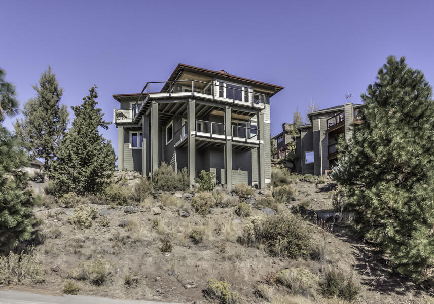 A one of a kind custom home in Bend's Golden Butte neighborhood with views that will knock your socks off. No detail was overlooked in the design and build of this Earth Advantage Platinum Home. Enjoy the luxurious appointments, huge vaulted ceilings and unobstructed views for miles. Construction highlights include: double wall construction, triple pane windows, heat ventilation recovery system, slab granite counters, hot water circulation pump. whole house sound system, and 12 solar panels.  
This thoughtful design allows for single level living with the primary suite, office, laundry, kitchen, and great room all on the main floor.  Downstairs provides the option of multi-generational living with a separate entrance,  kitchenette, two bedrooms with en suites and a 4th bedroom that could be a family/bonus room. Expansive, low maintenance decks wrap around the NW & SW sides of the home.  An oversized 2 car garage with epoxied floors, built in storage and a large utility sink
