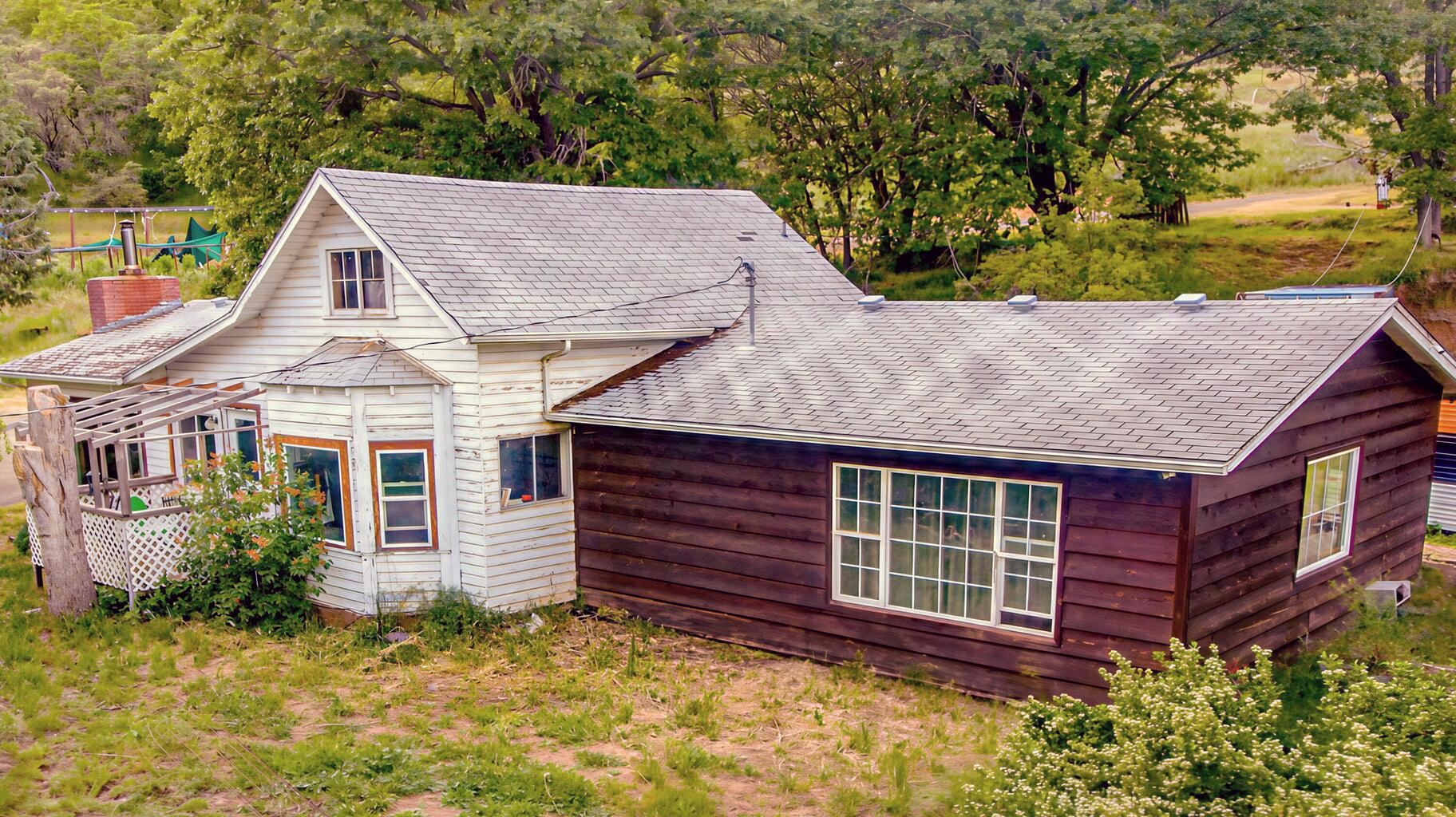 A rare opportunity to own peaceful acreage with a move-in ready home, all close to town amenities. Just eight minutes from the charming historic town of Jacksonville, this delightful 2-bedroom, 1-bathroom home presents a unique opportunity to embrace tranquil country living without sacrificing convenient access to urban amenities. Spanning a comfortable 1,219 square feet, the residence offers a warm and inviting atmosphere, perfect for those seeking a peaceful retreat. The true allure of this property lies beyond the walls of the home, encompassing a sprawling 34.91 acres of picturesque, rolling countryside.  With 2 inactive gold mines. This expansive land boasts sunny, thoughtfully terraced gardens, ideal for gardening, or simply enjoying the beauty of nature. Furthermore, the property directly borders Bureau of Land Management (BLM) land, granting unparalleled access to a vast network of outdoor recreational opportunities.