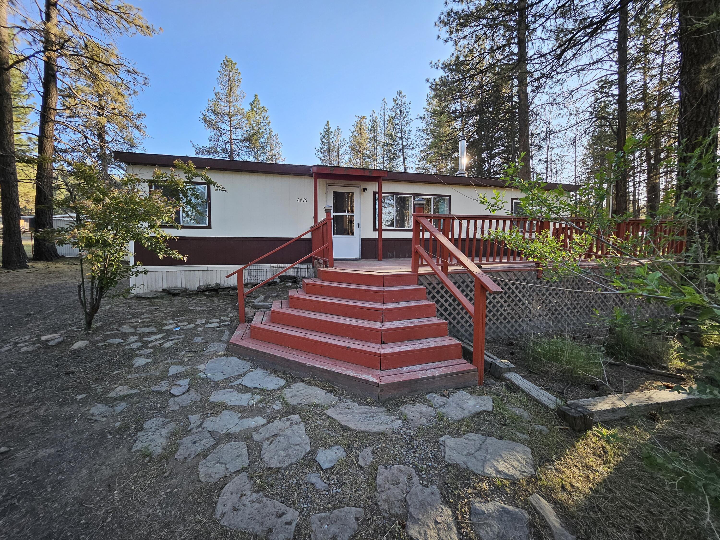 A home with room for your horses!  This cozy 3 bedroom 2 bathroom home sets on over 2 acres.  Home features an updated kitchen and laundry area. Newer flooring and updated bathrooms.  If you enjoy sitting on a deck and listening to the birds sing than this is the deck for you.  In the back you will find a loafing shed for your horse and a gate from the pen to ride the back part of your land. Additional outbuildings include a newer shed, newer car port, pump house, chicken coop, small green house and a garden shed.  Come take a look, this may be the home you've been wanting!