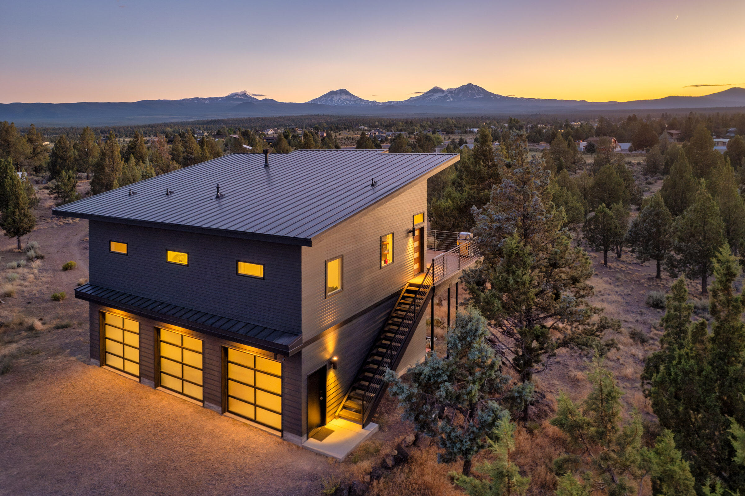 Stunning Midcentury Modern Home with Year-Round Mountain Views. Enjoy breathtaking mountain views every day from this beautifully updated midcentury modern home, situated on 15 fully fenced private acres.This 2-bedroom, 2-bathroom residence offers a seamless blend of modern upgrades and timeless design. Inside, you'll find newly installed hardwood floors throughout, fully remodeled bathrooms, and fresh exterior paint. The open living space flows effortlessly to a large deck perfect for entertaining, relaxing, or watching the sunset from your hot tub.
A fully finished 120 sq. ft. outbuilding with a mini-split system provides flexible space for a home office, guest suite, yoga studio, or creative retreat. Put the oversized 3 car garage to use with all your central oregon toys. The property is zoned for livestock, bring your horses, cows and more. A rare opportunity to own usable acreage with privacy, stunning views, and versatile living options,  including power hook-ups for an RV.