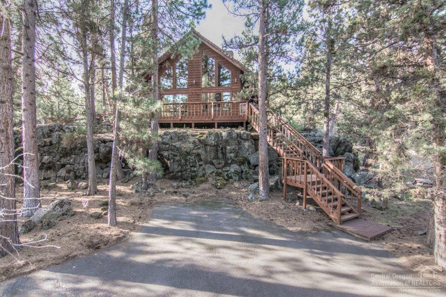 Sit on your front porch and listen to the river. This beautiful NW Bend home is just steps from the Deschutes River in desirable Rimrock West subdivision at the base of Awbrey Butte. This one of a kind home allows all the convenience of town with the ultimate feeling of seclusion. See nothing but trees and open space from every room in the house. Stunning rock fireplace and beautiful hardwood flooring make this gem in the woods the perfect full time home or easy to maintain vacation getaway.